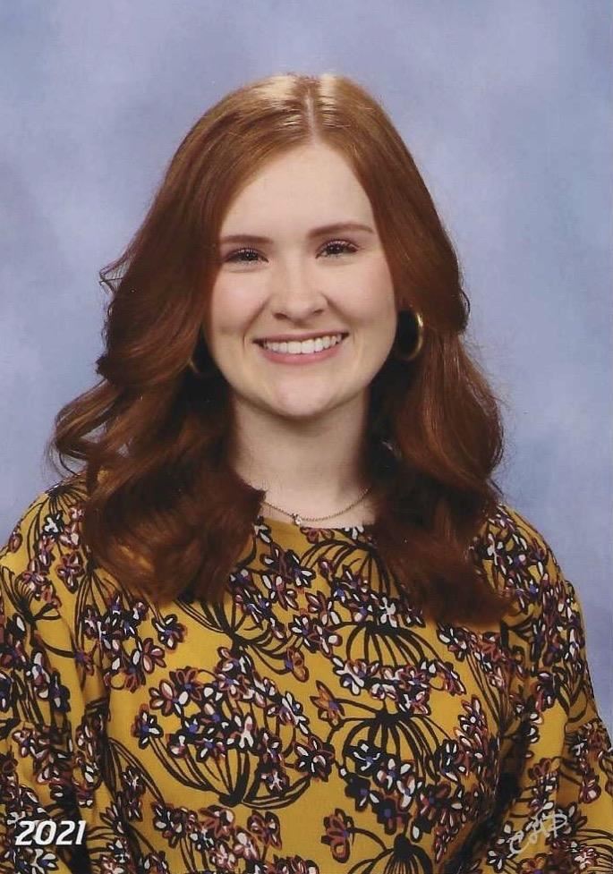 Smiling woman wearing mustard yellow floral print blouse