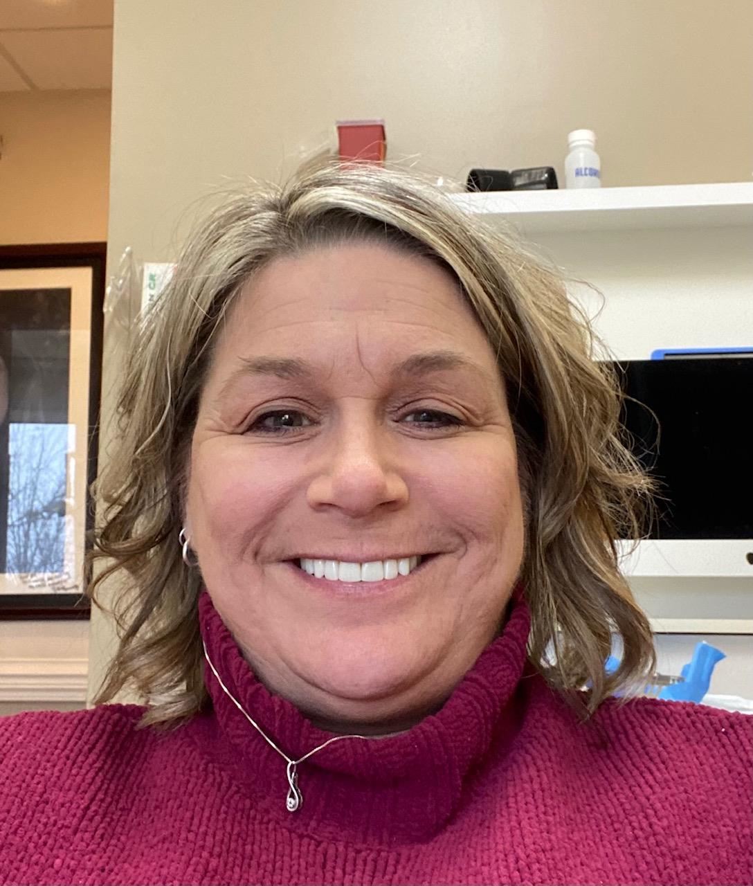 Smiling woman wearing red turtleneck sweater