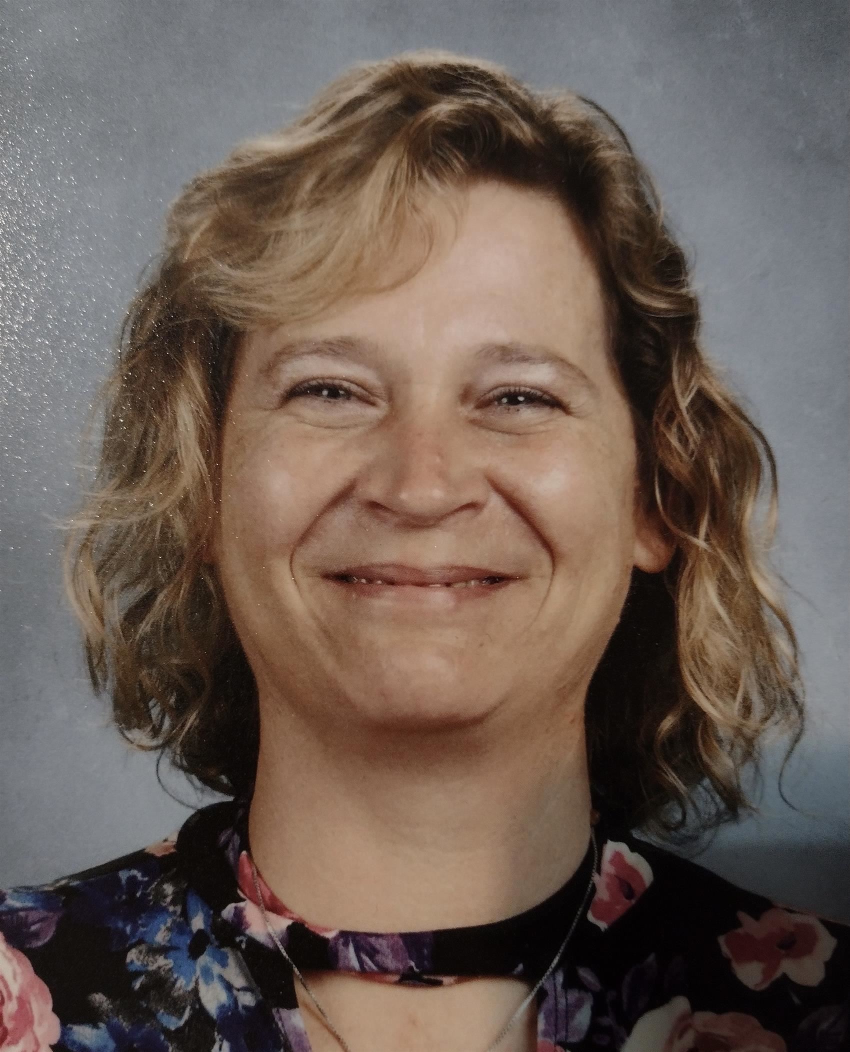 Smiling woman in front of gray background