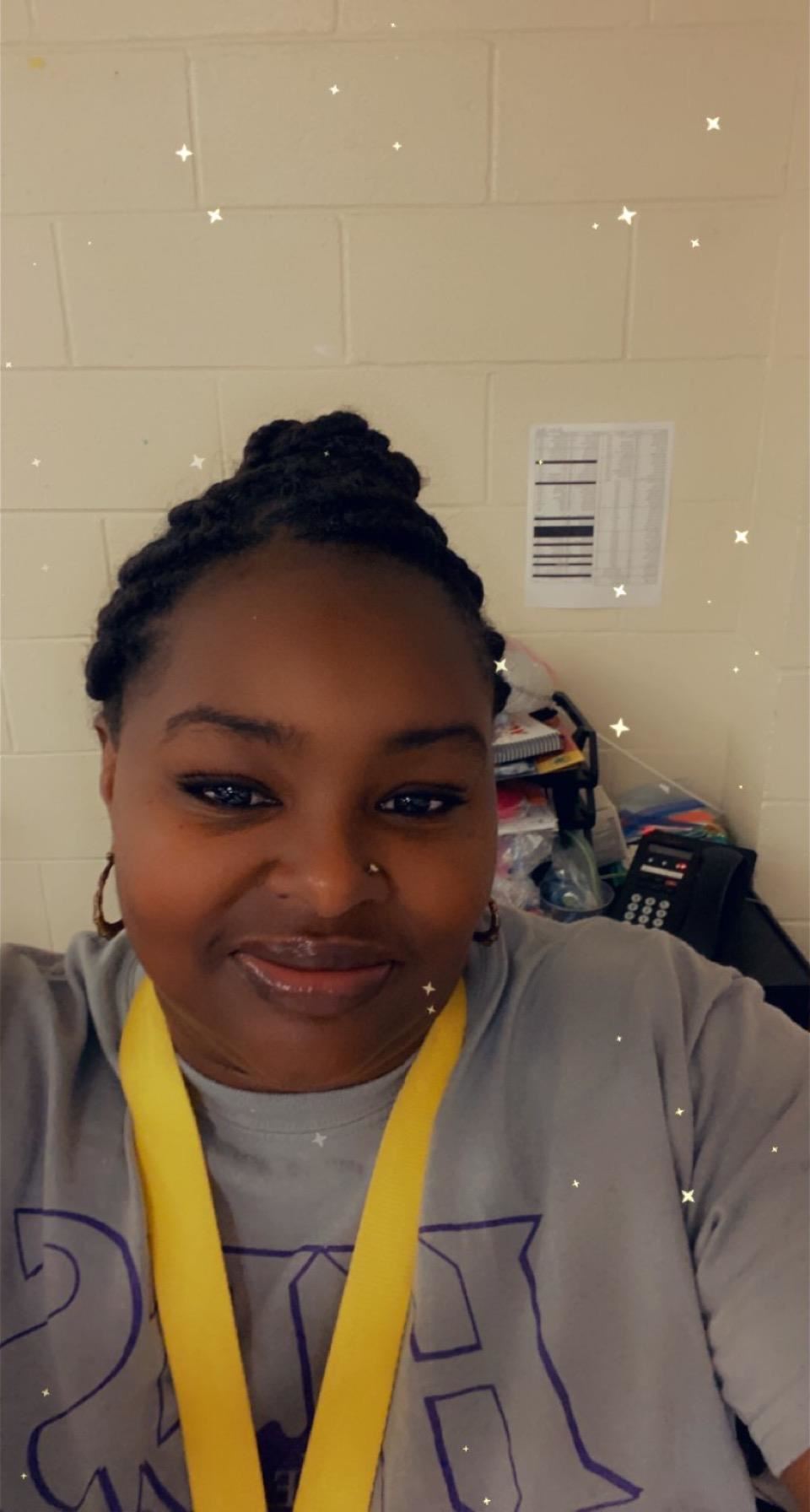 Woman wearing gray top and yellow lanyard