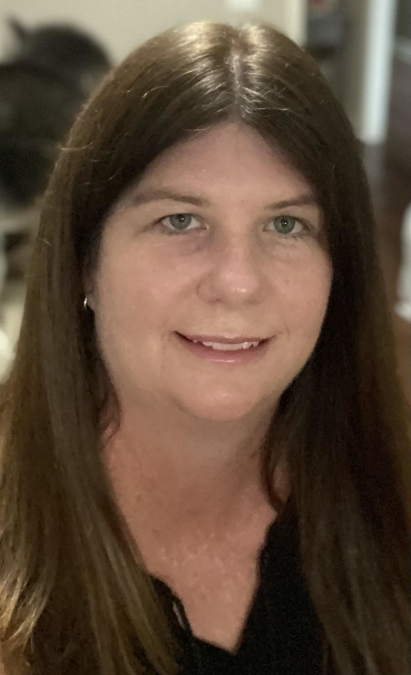 Smiling woman wearing dark blouse