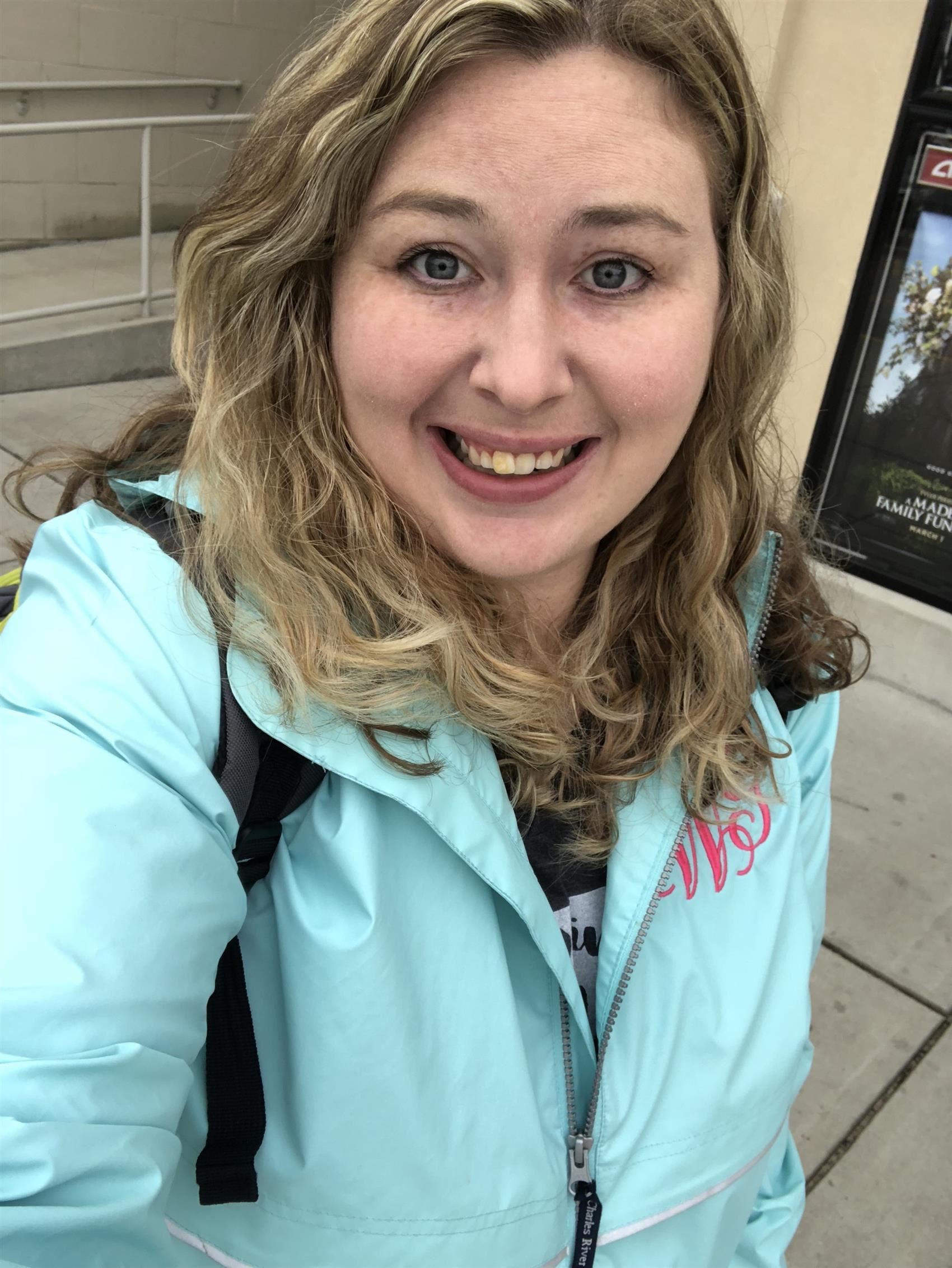 Smiling woman wearing light blue coat