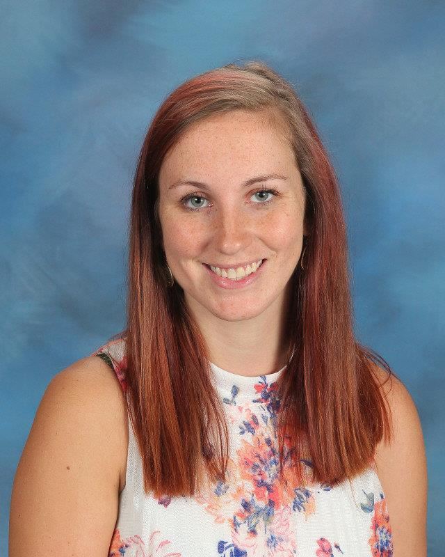Smiling woman wearing white floral blouse