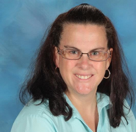Smiling woman wearing light blue shirt