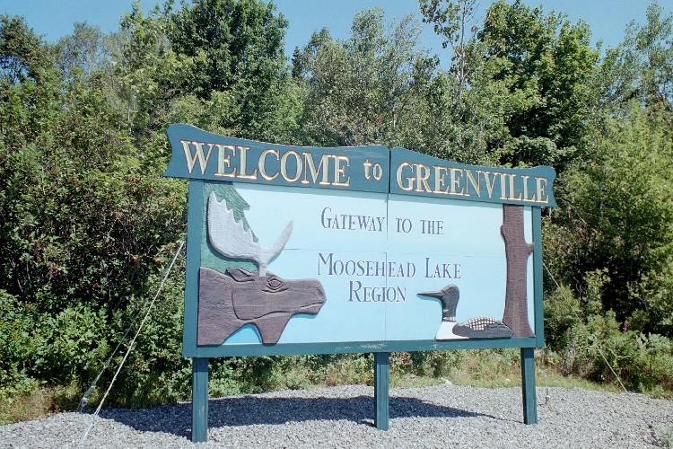 Welcome to Greenville Sign with Moose and Duck on it. Reads: Gateway to the Moosehead Lake Region