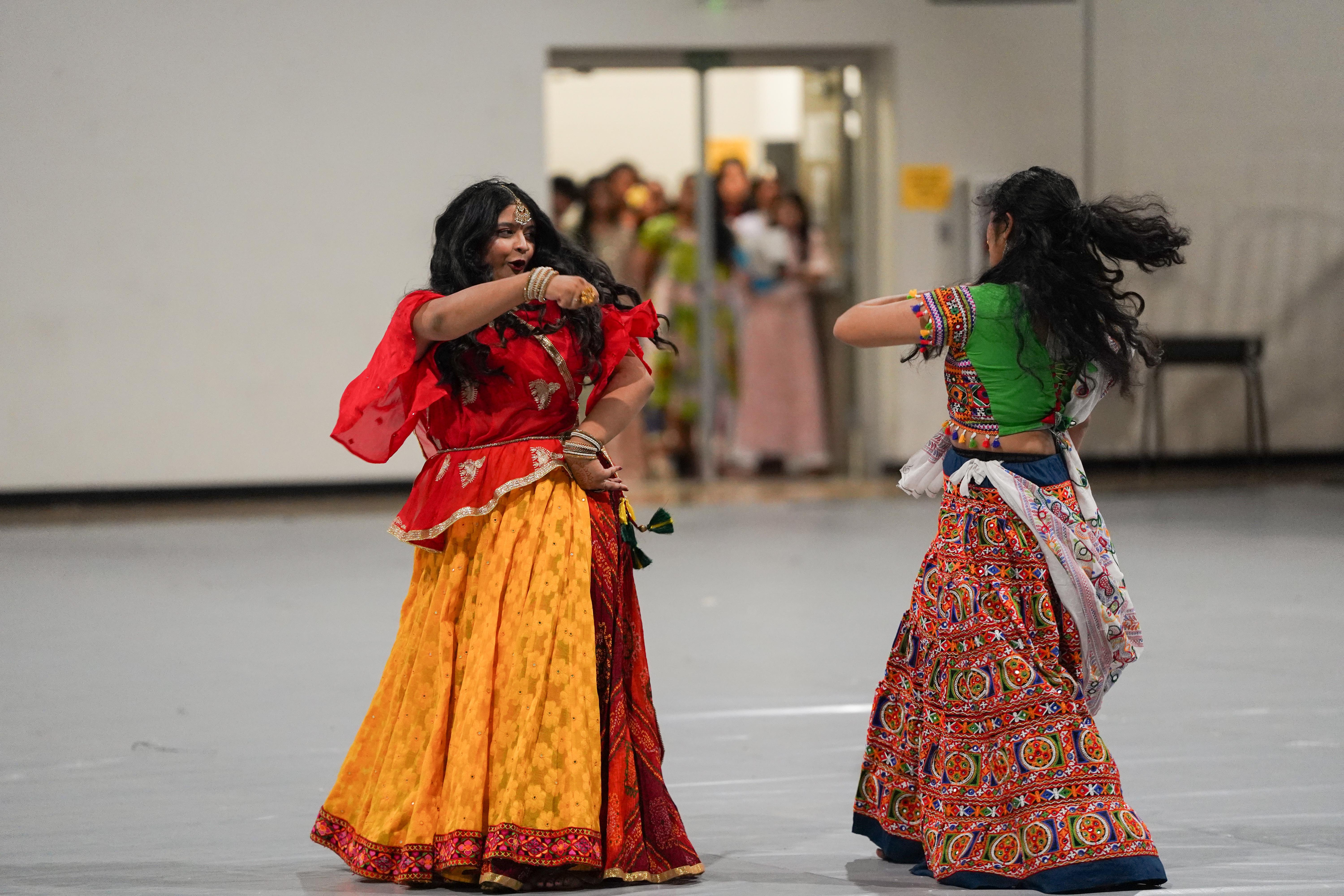 2 girls performing a traditional indian dance