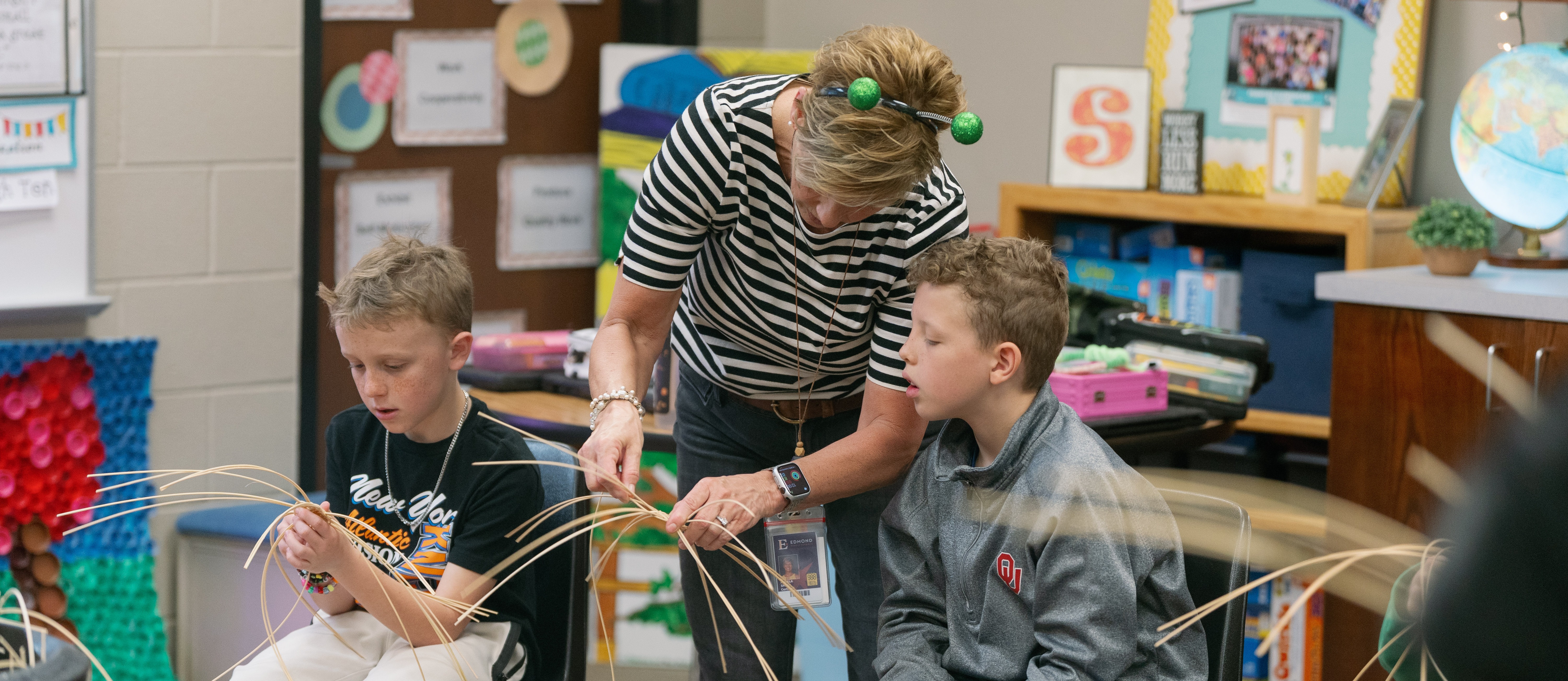 teacher helping a student basket weave