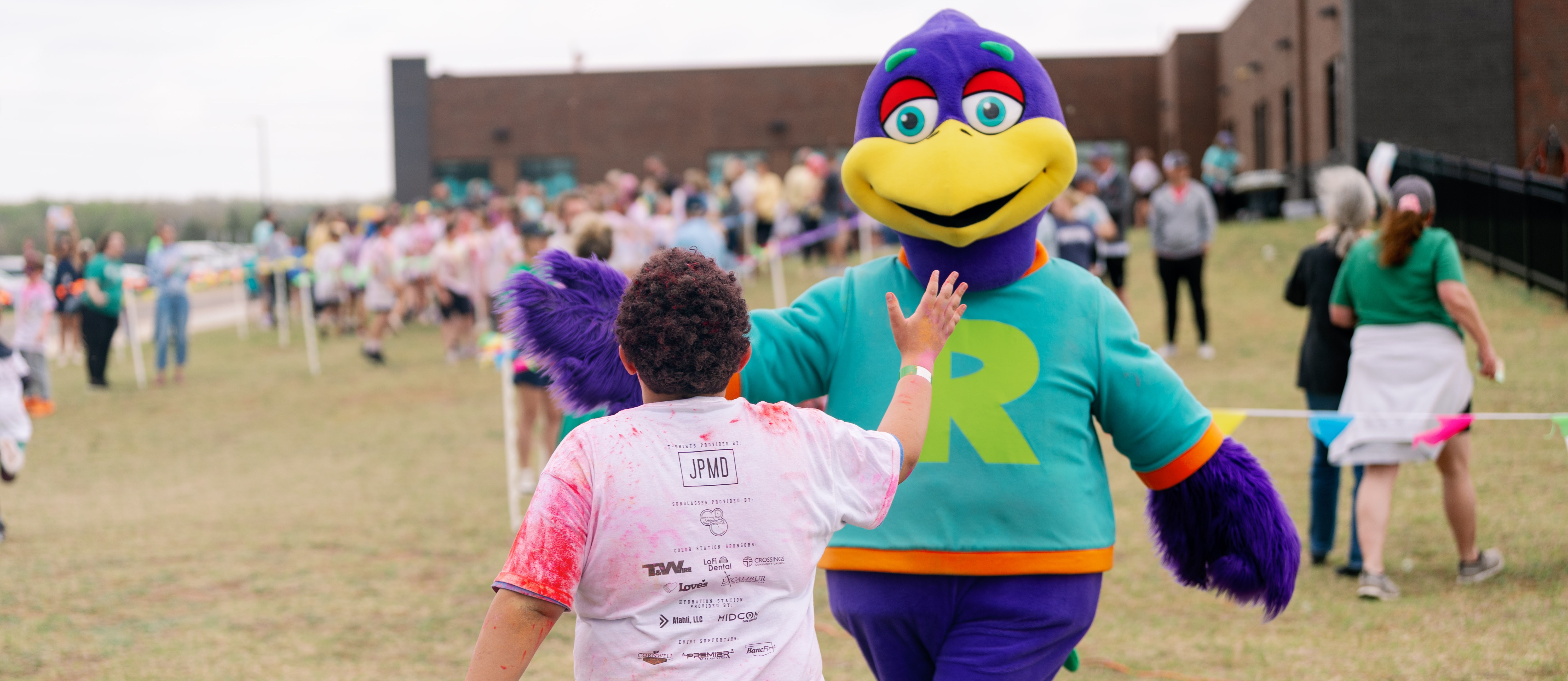 mascot high fiving a student
