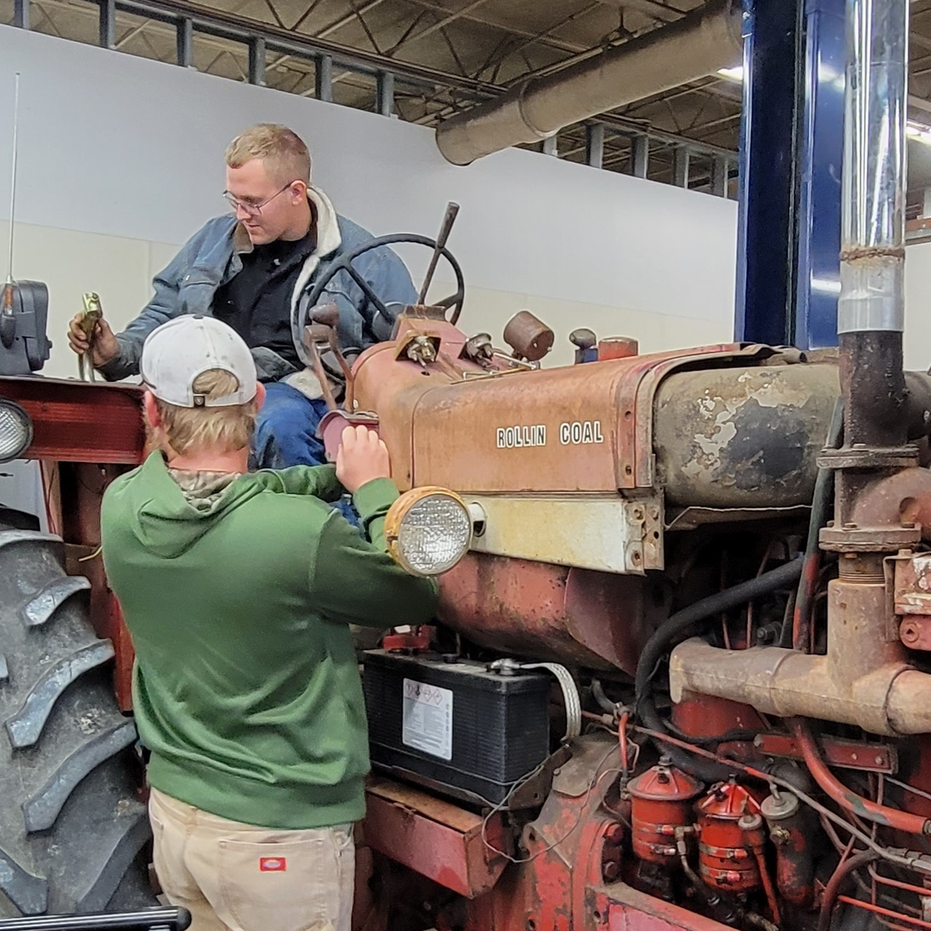 student team up to troubleshoot issue with tractor