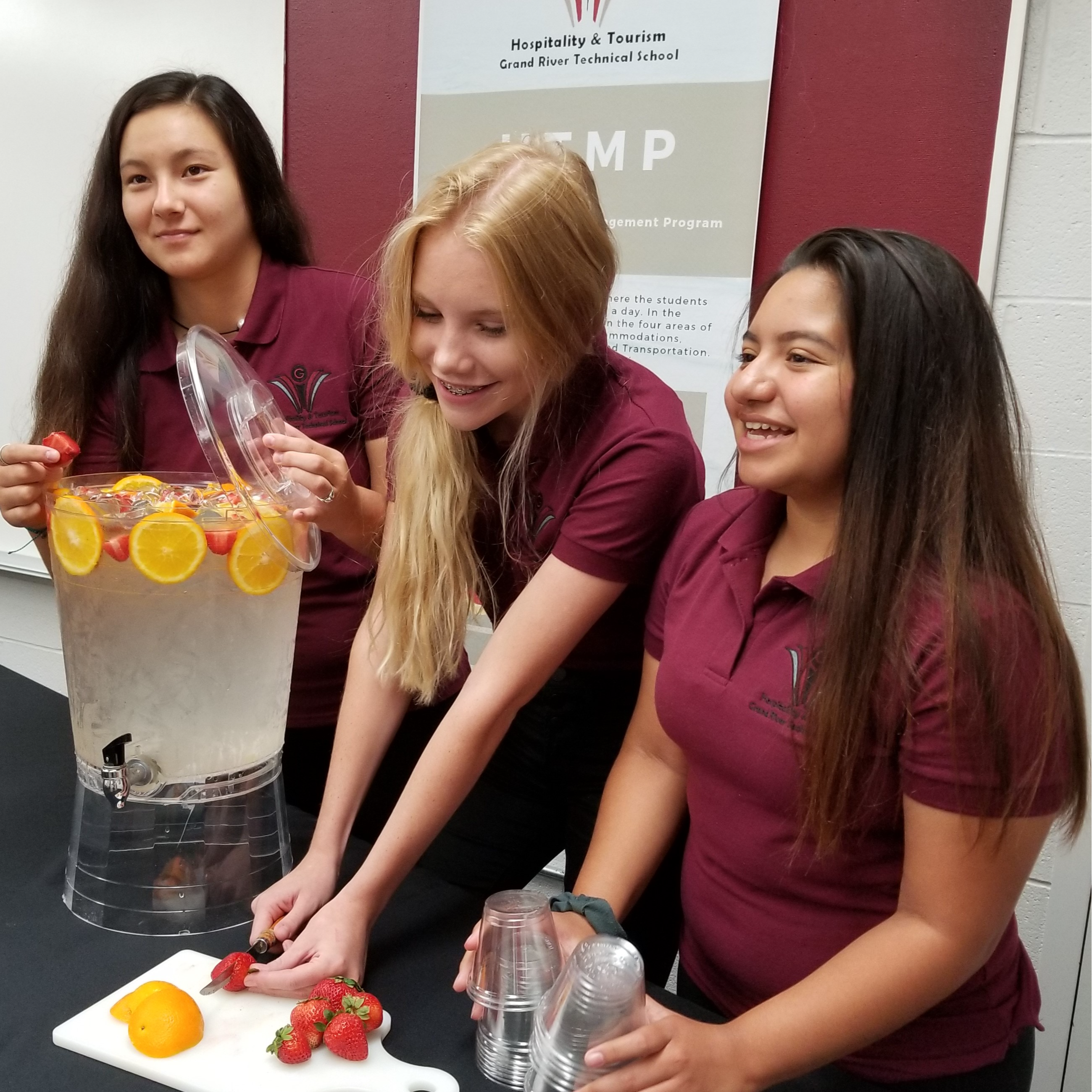 students are preparing fruit infused water for service