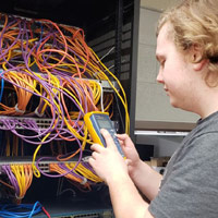 Computer Service student diagnosing problems with network cables