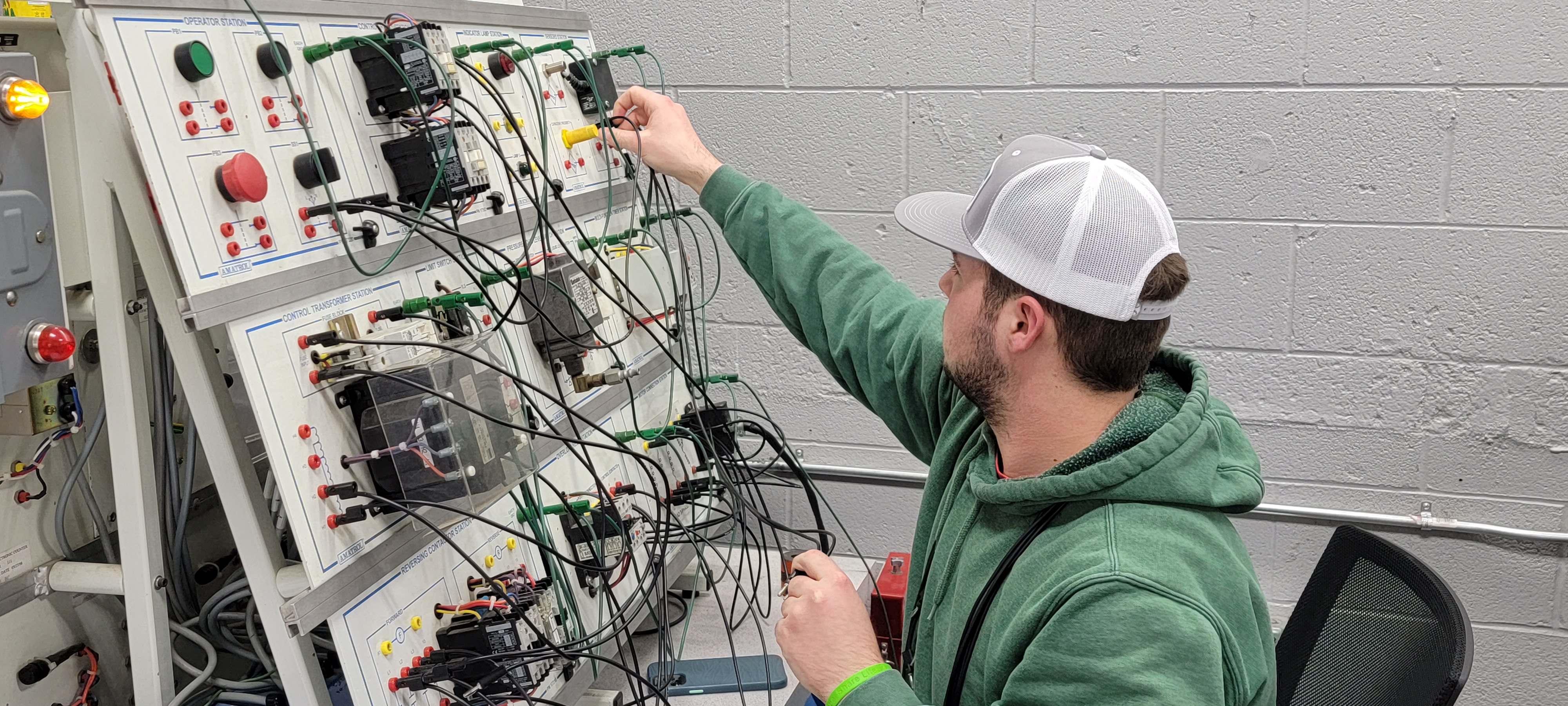 Automation and Electrical Technology student working on electrical grid board