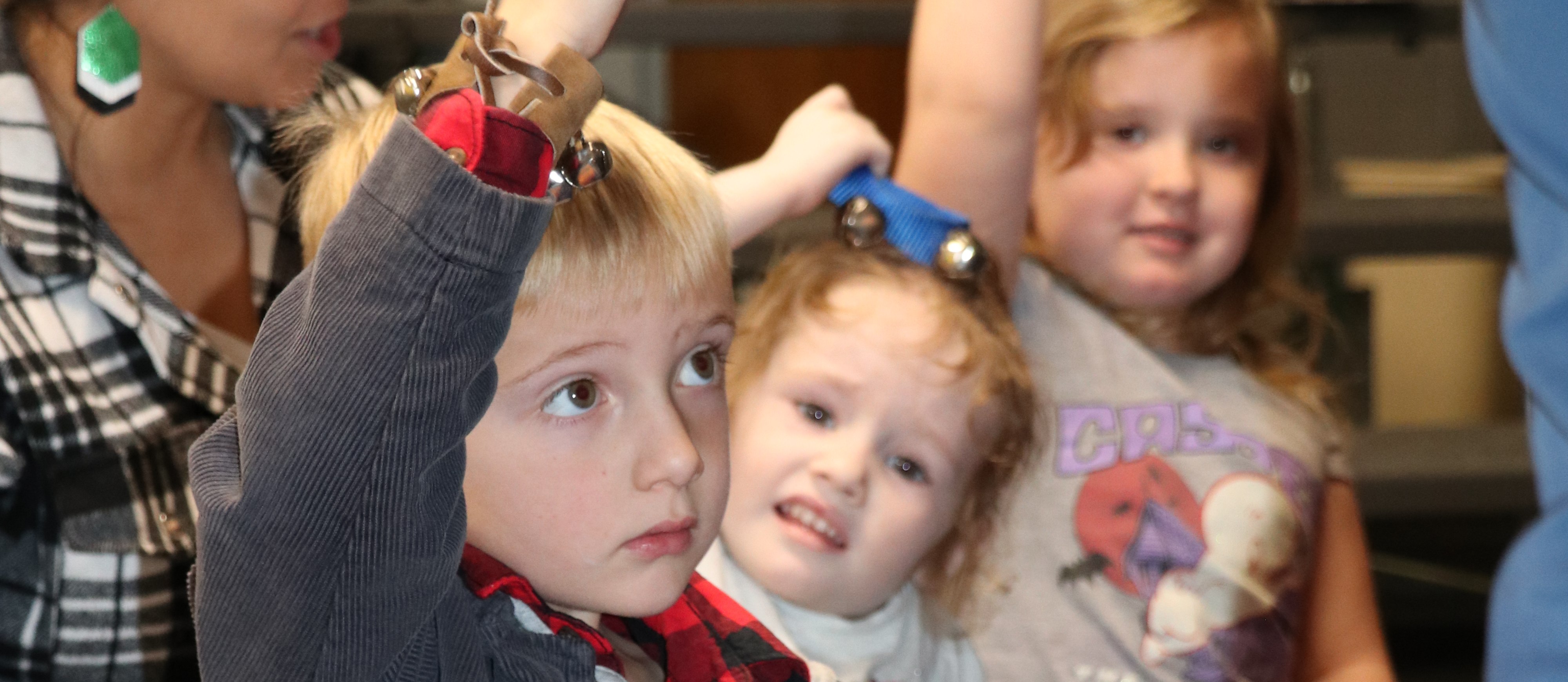 Preschool students shake bells in music class