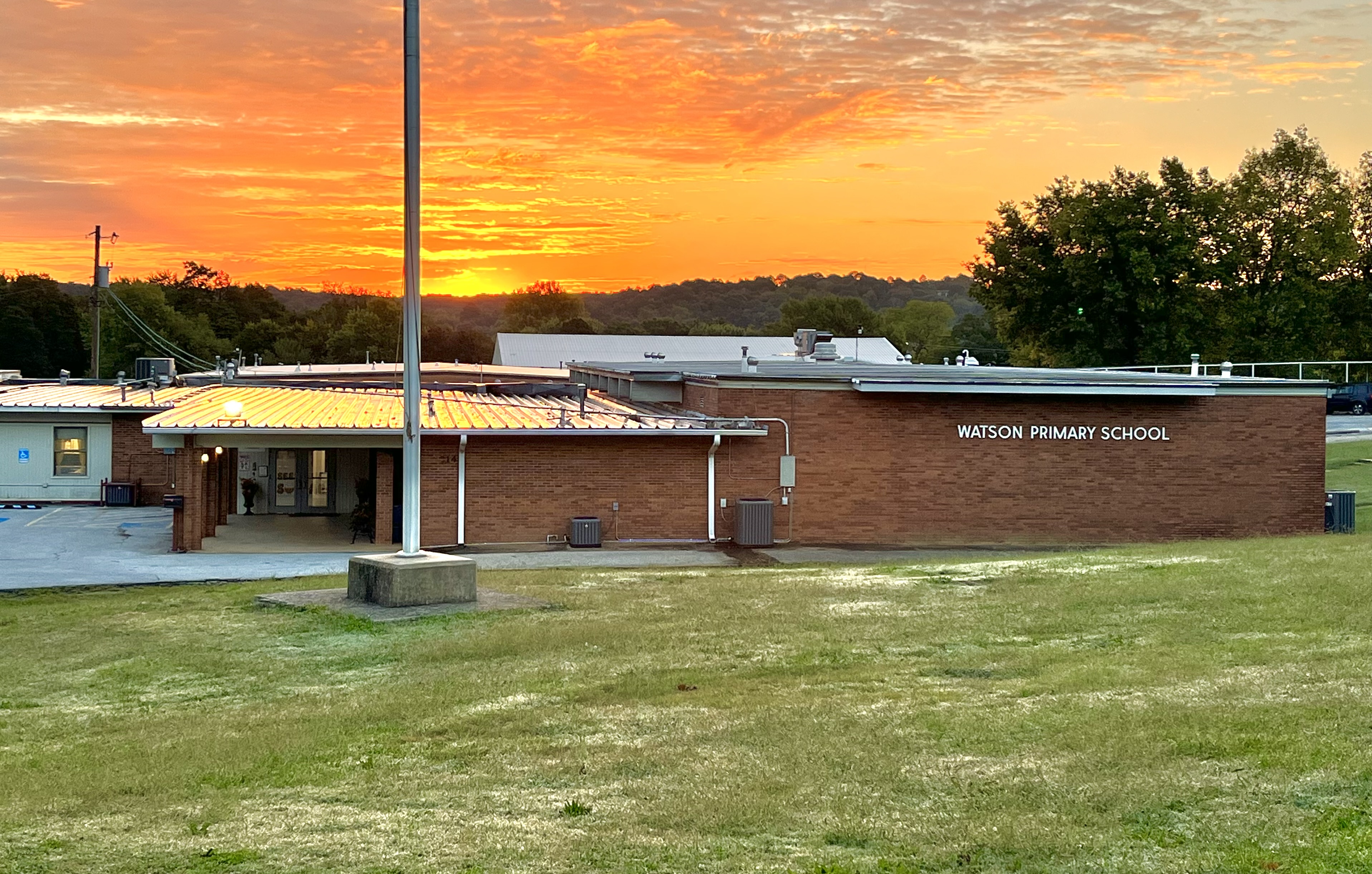 School with sunrise behind it
