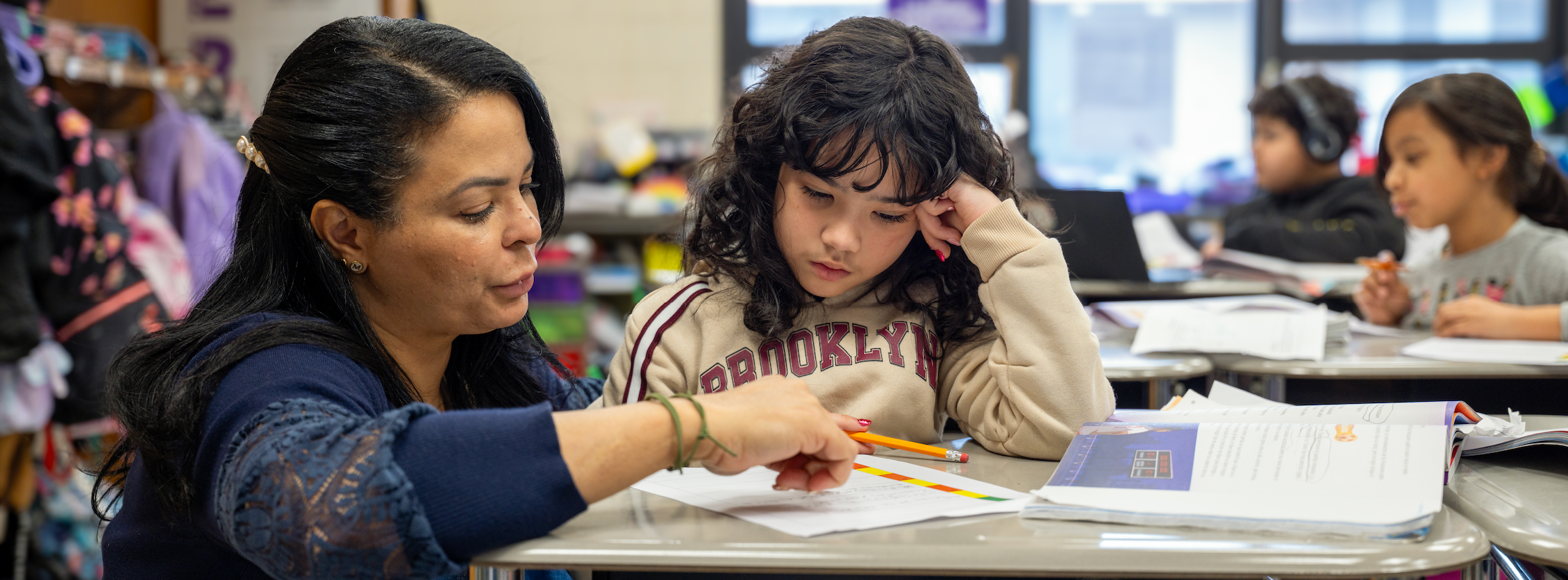A teacher assists a student