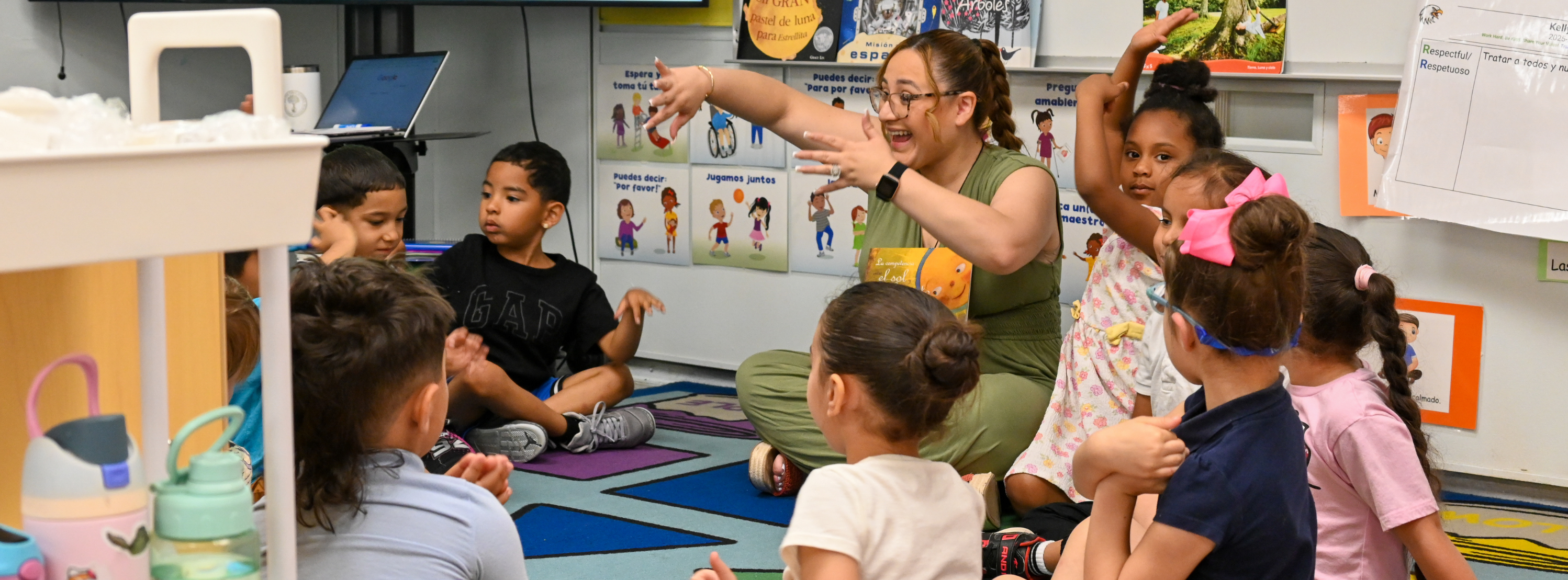 students sitting in a circle listening to a story