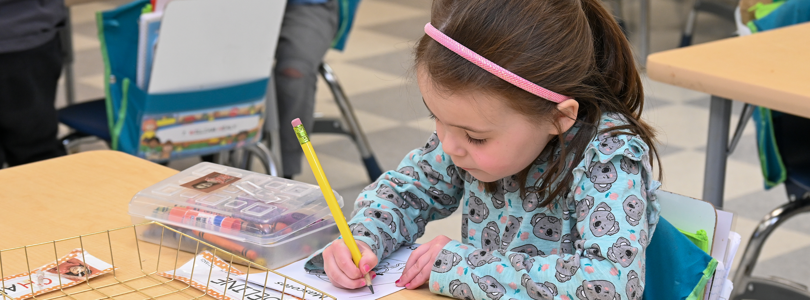 Student writes on a worksheet