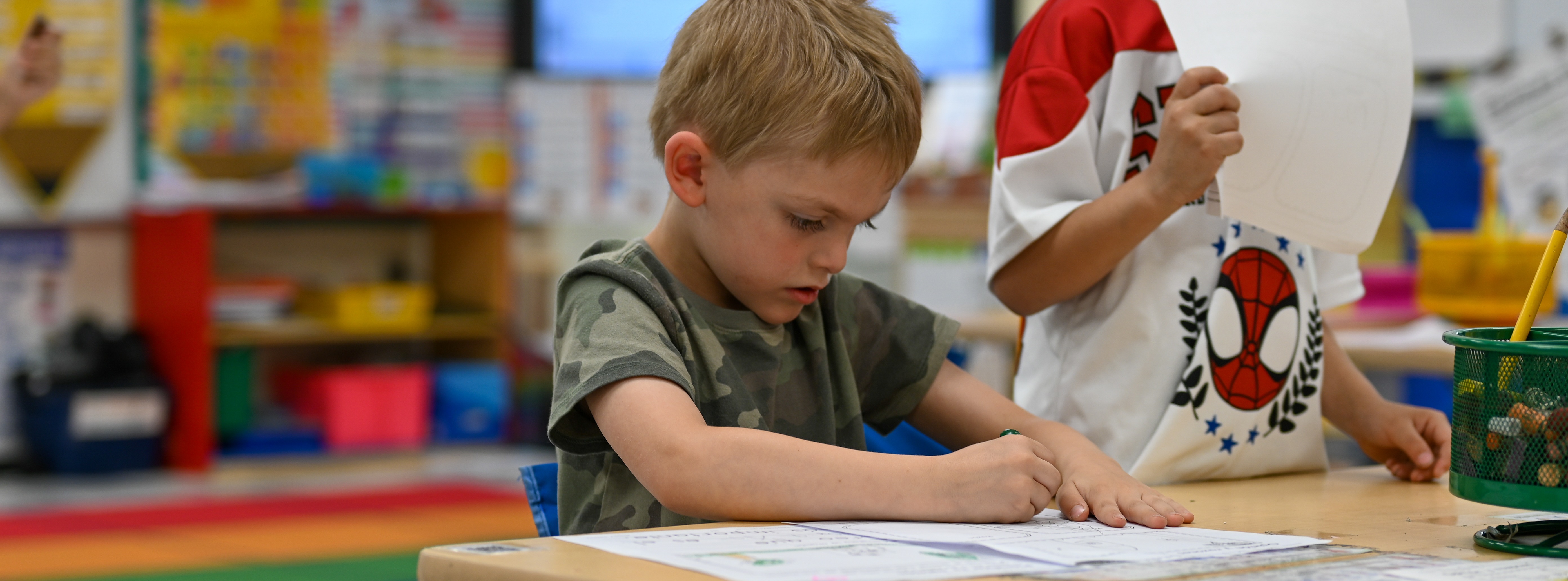 student sitting at table working on an assignment