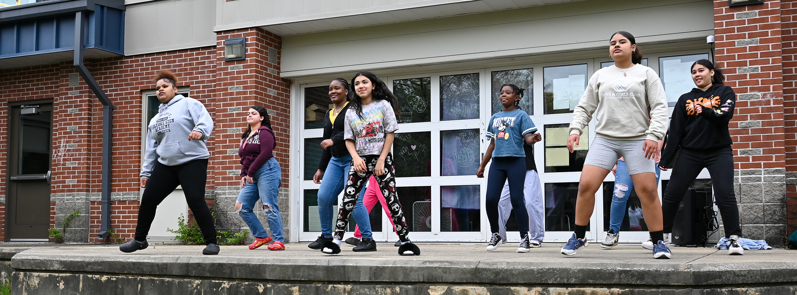 Dance team practices on courtyard stage