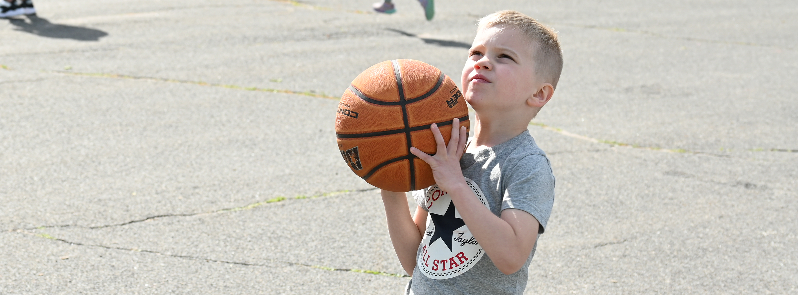 A student prepares to throw a basketball