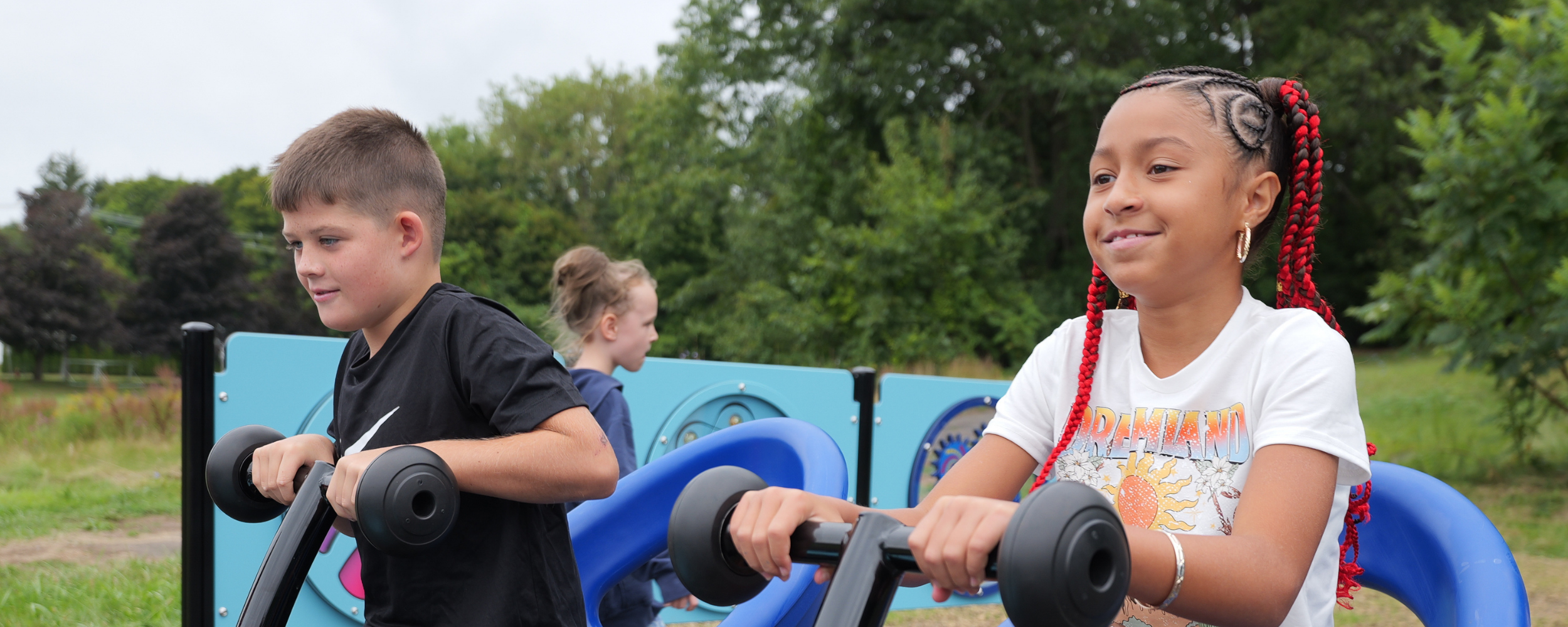 Students on the new playground try out the equipment