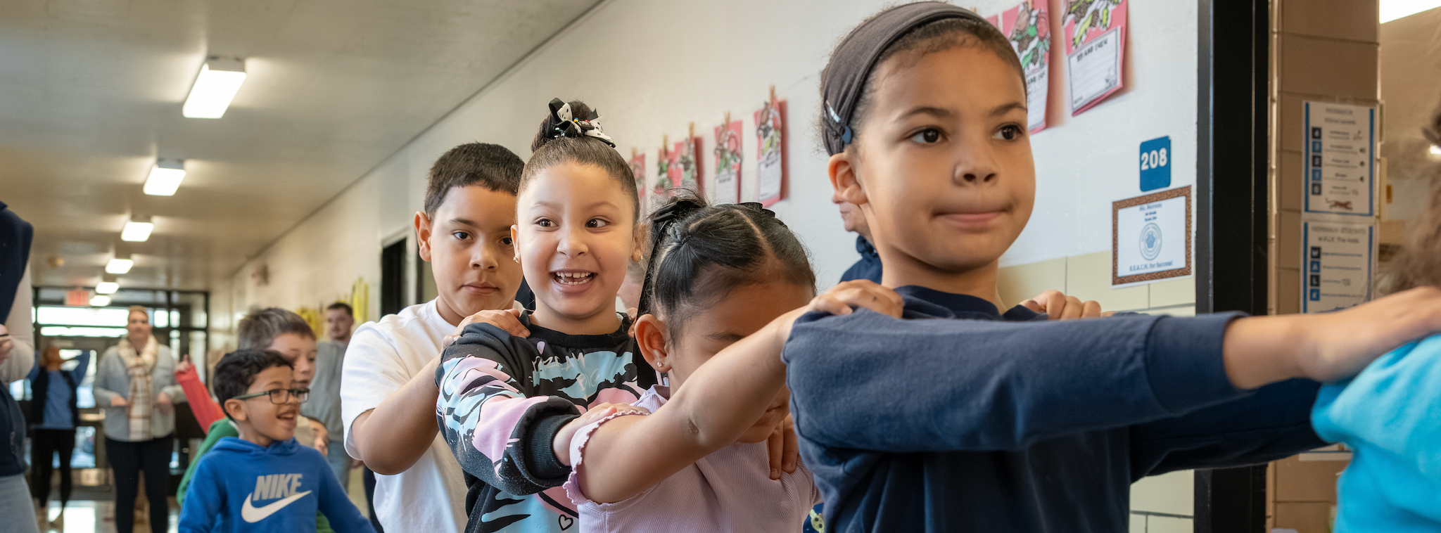Students perform in a conga line during a Friday dance party