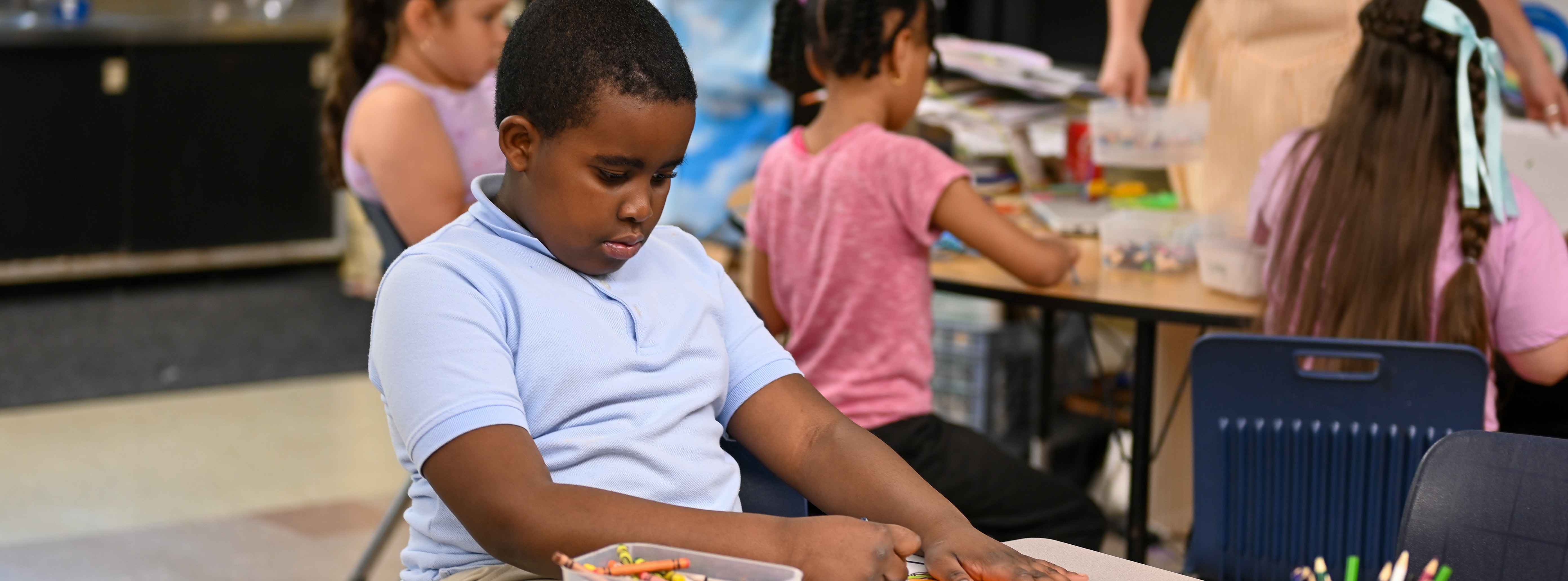 student coloring at his desk