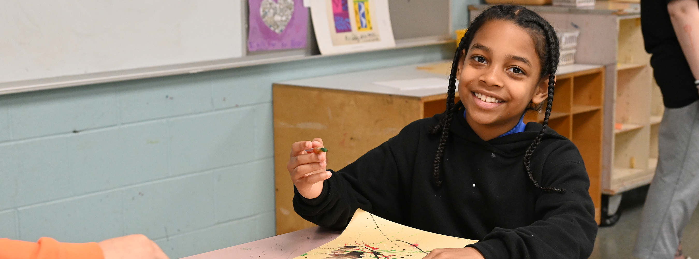 A student smiles in art class