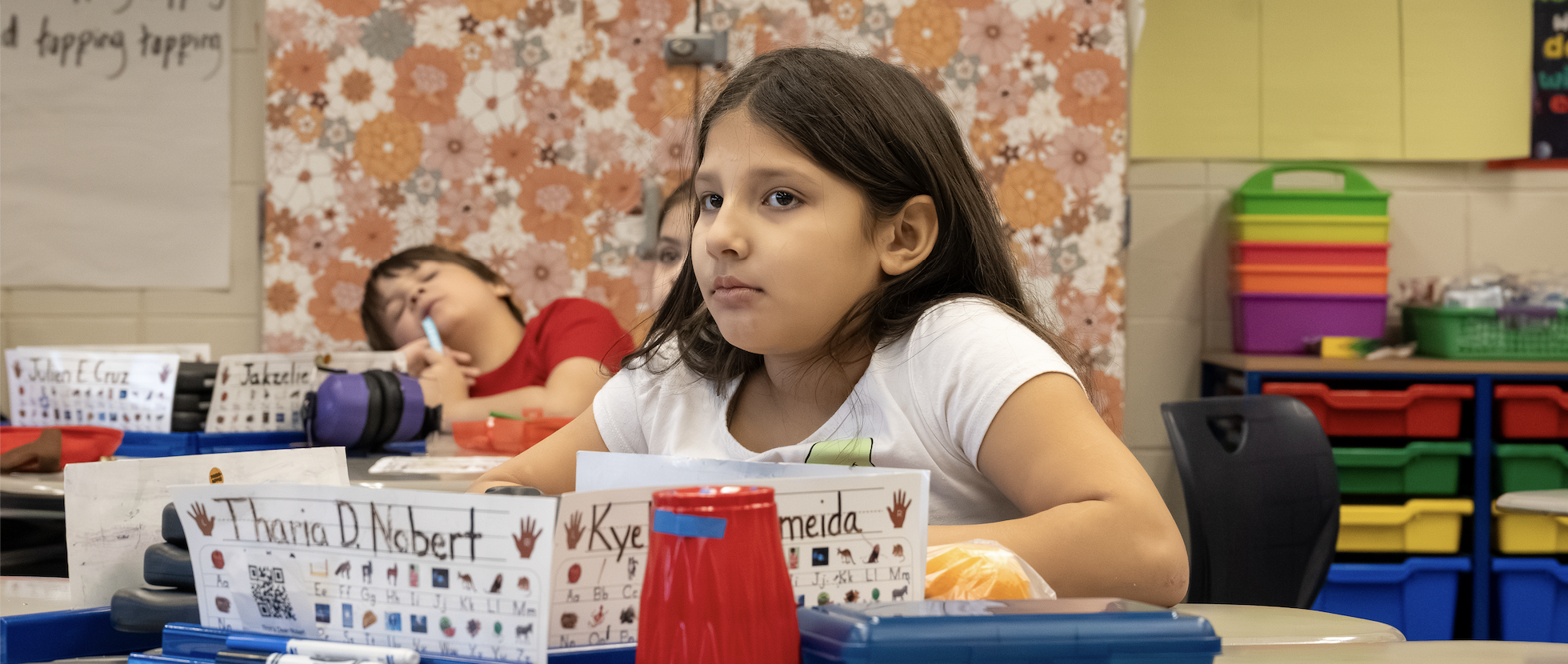 A focused student looks at her teacher