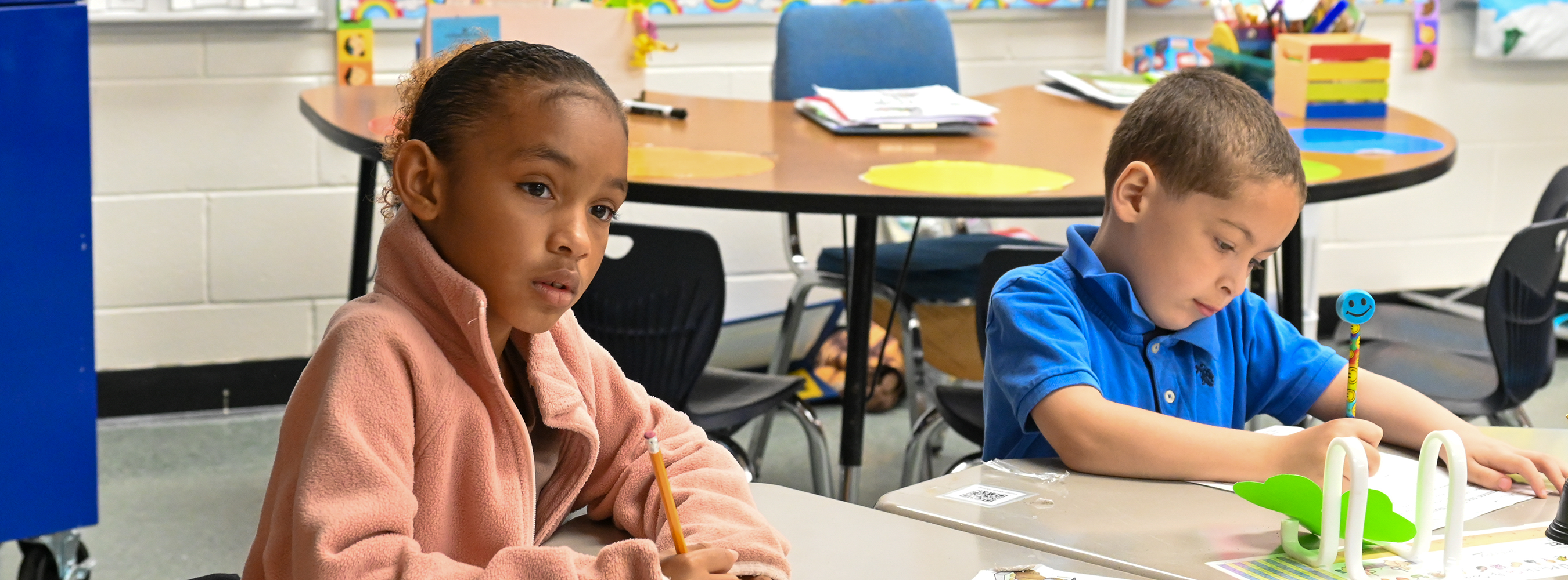 Two students consider a question in class