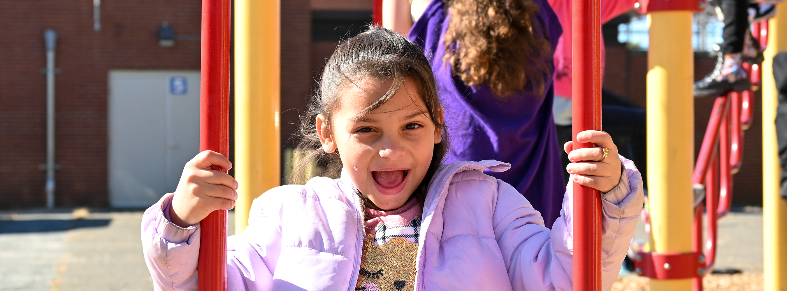 A Morgan student laughs on the playground