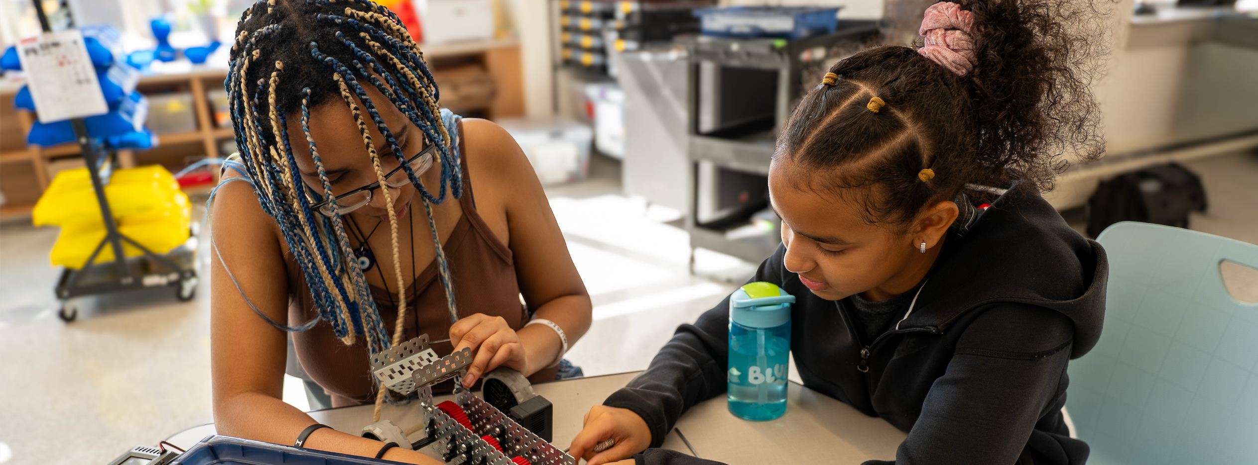 Two students work on a robotics project 