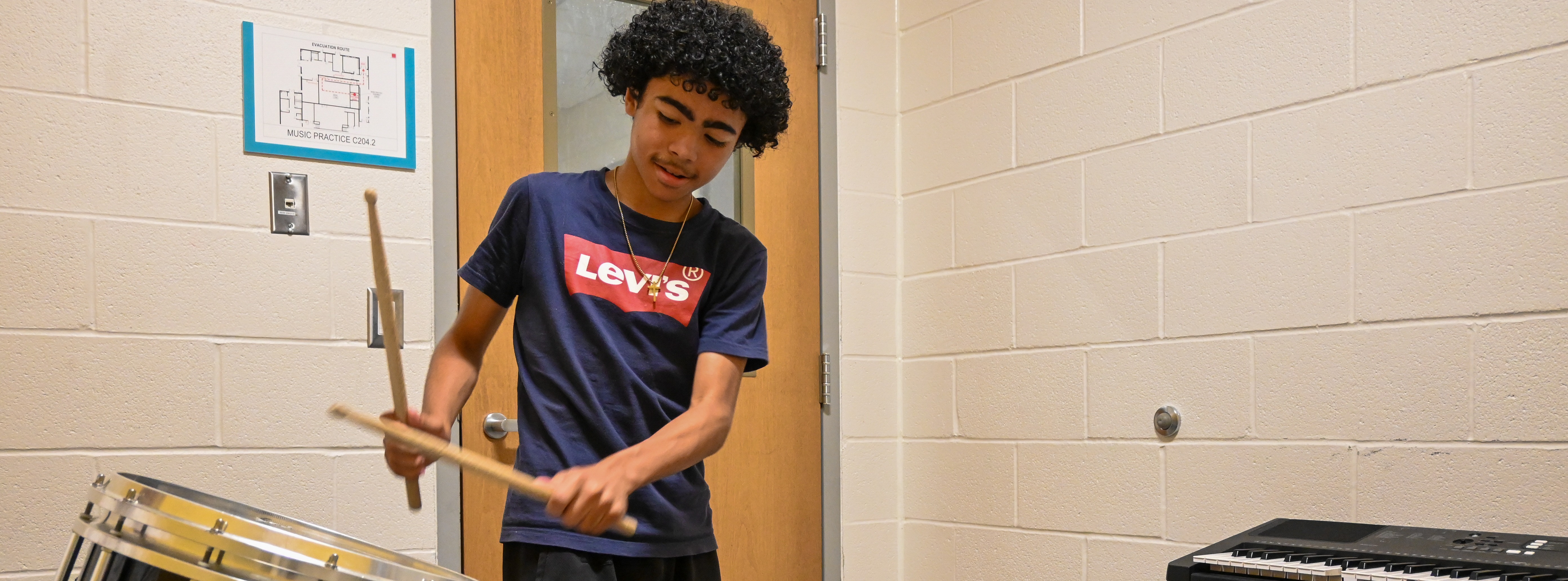 student playing the drums