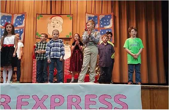 children on a stage performing