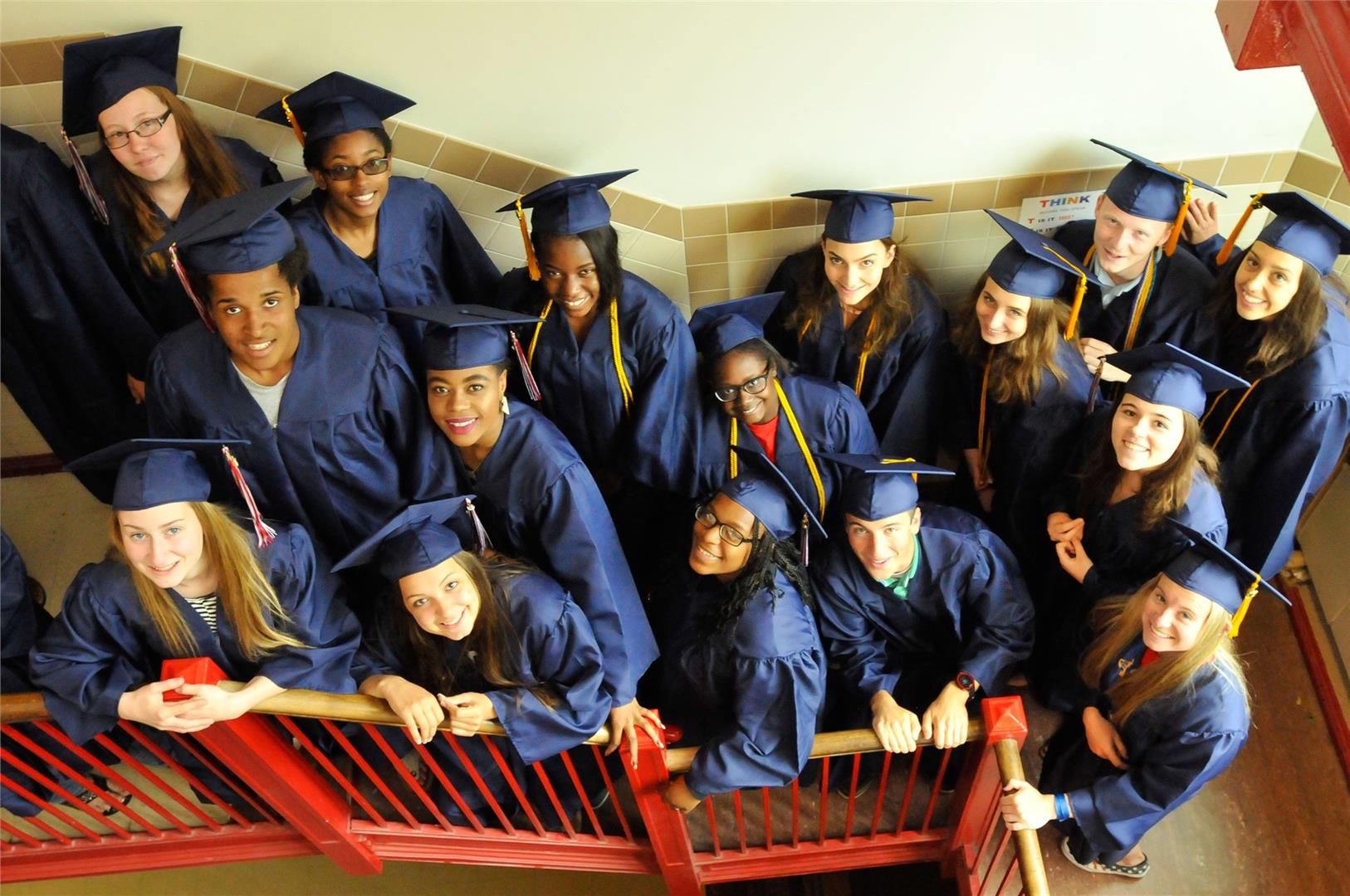 Group of teens in graduation gowns