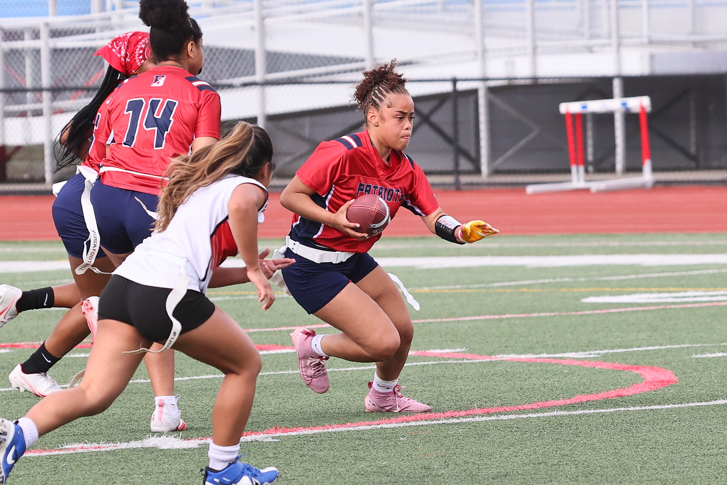 flag football player runs with ball