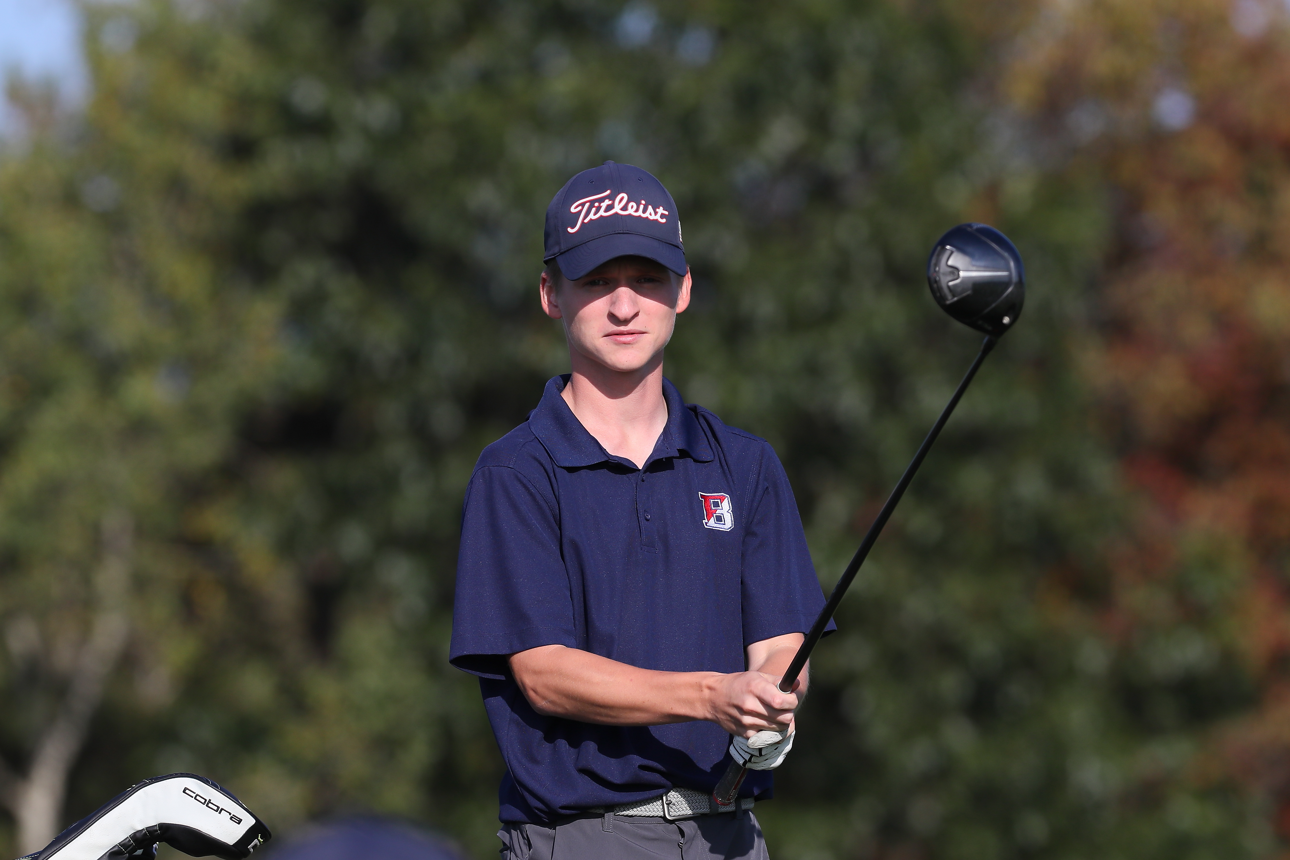 golfer holds club in front of his body