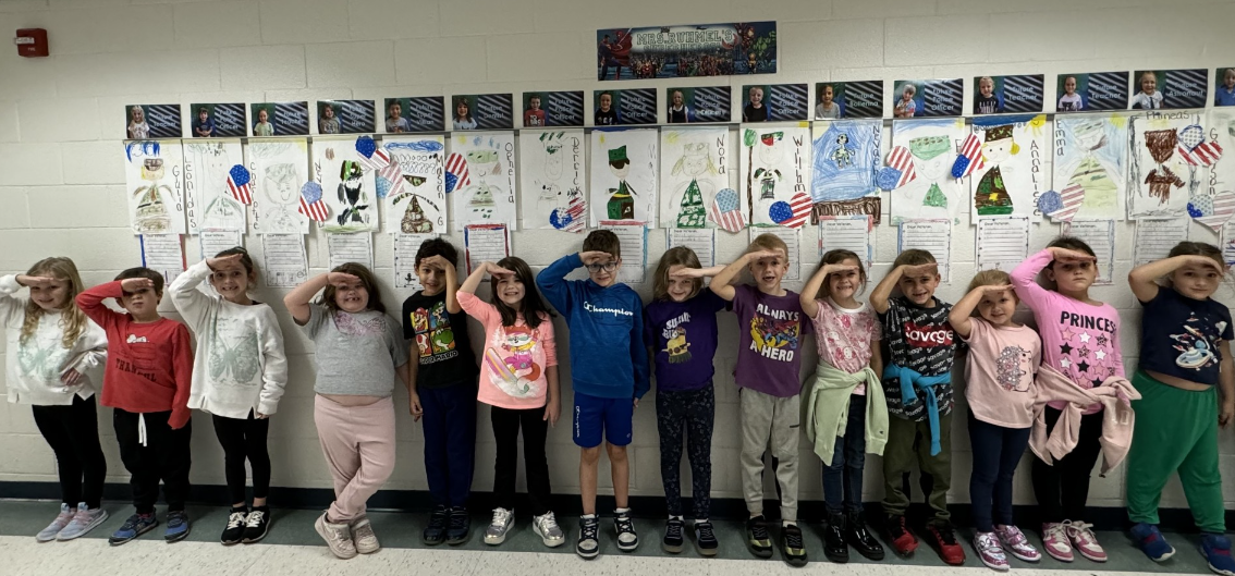 students salute with flags