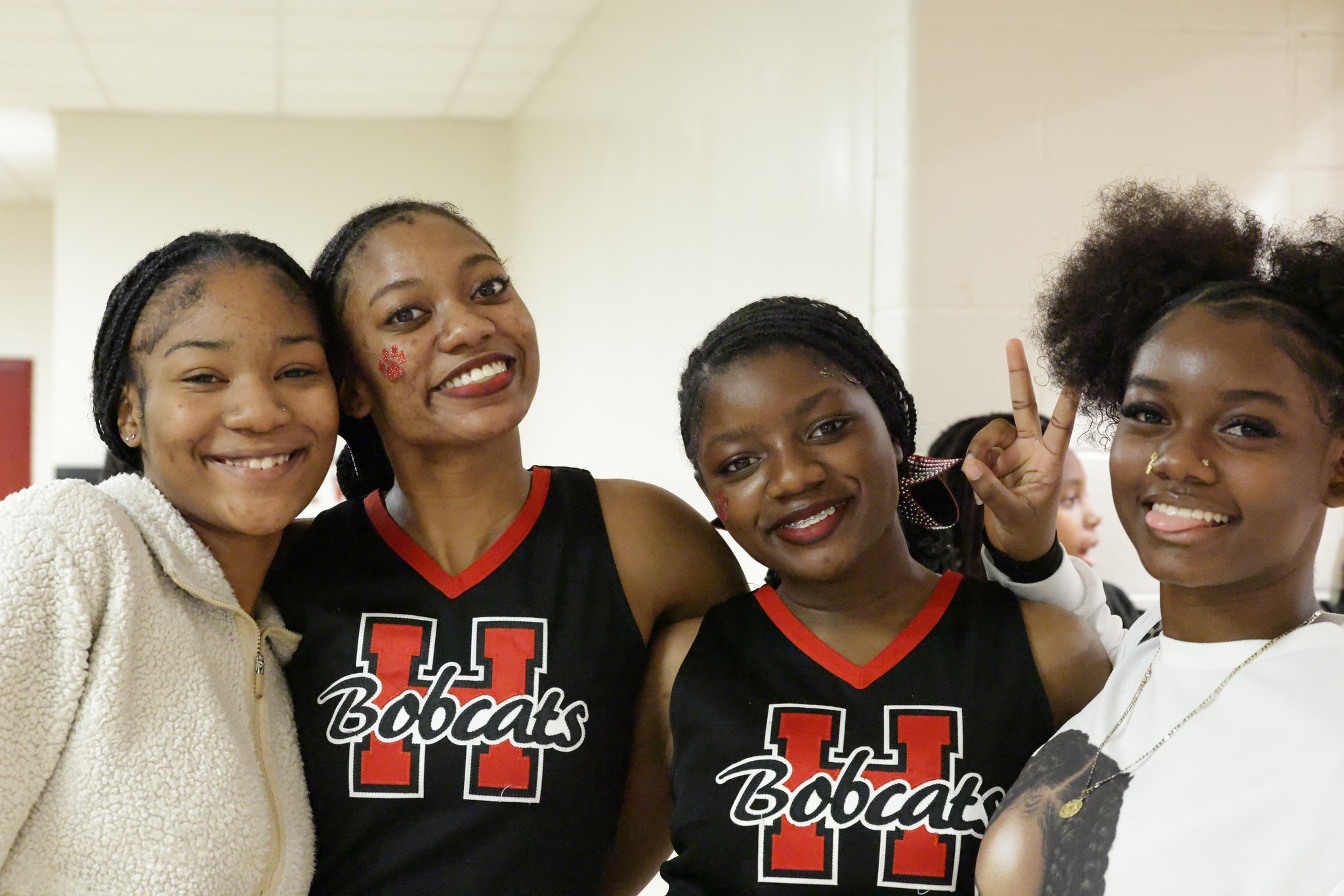 students smiling at basketball game