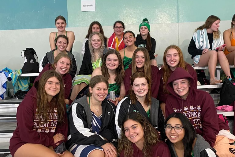 Team poses for picture at swim meet