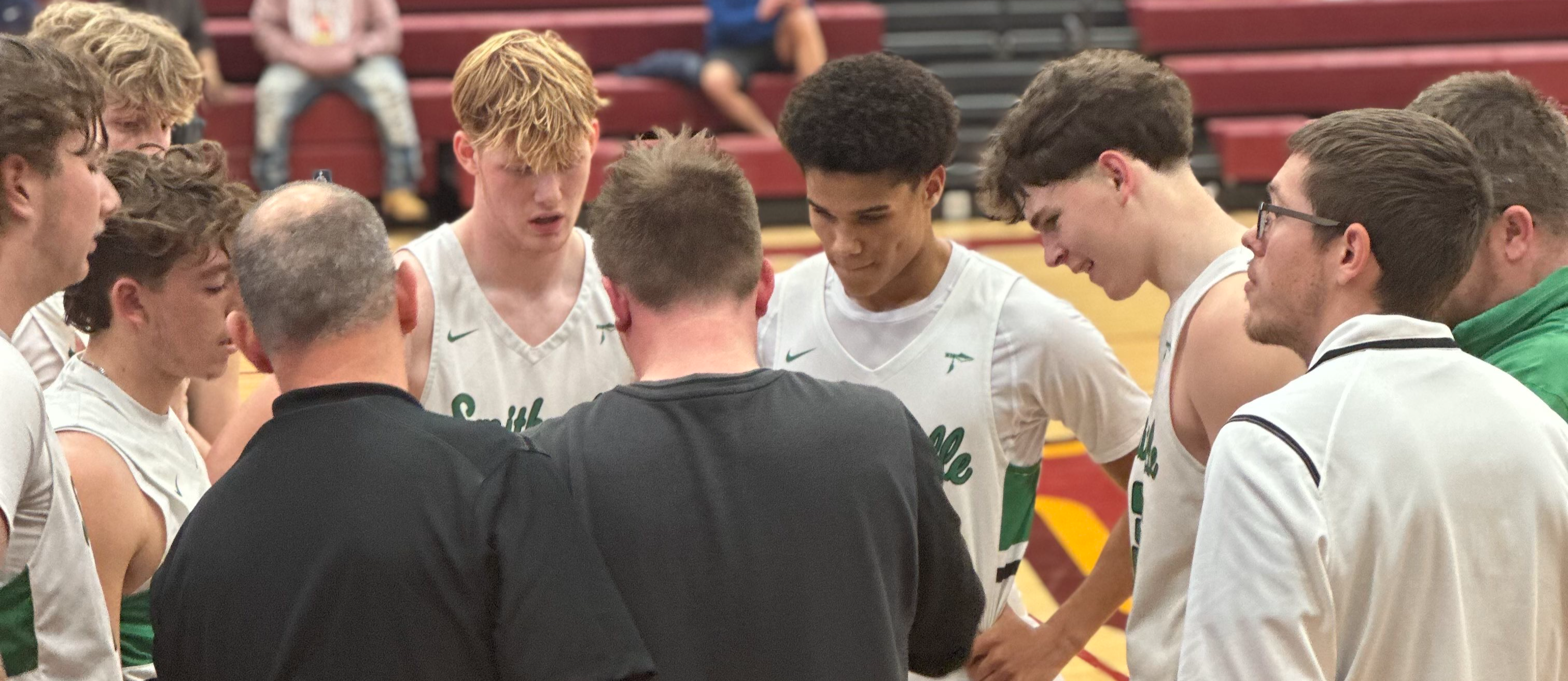 Boys basketball team in a huddle