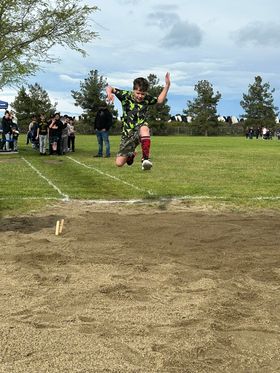 Student mid air during long jump