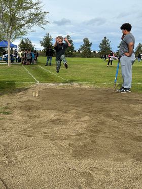 Student mid air during long jump