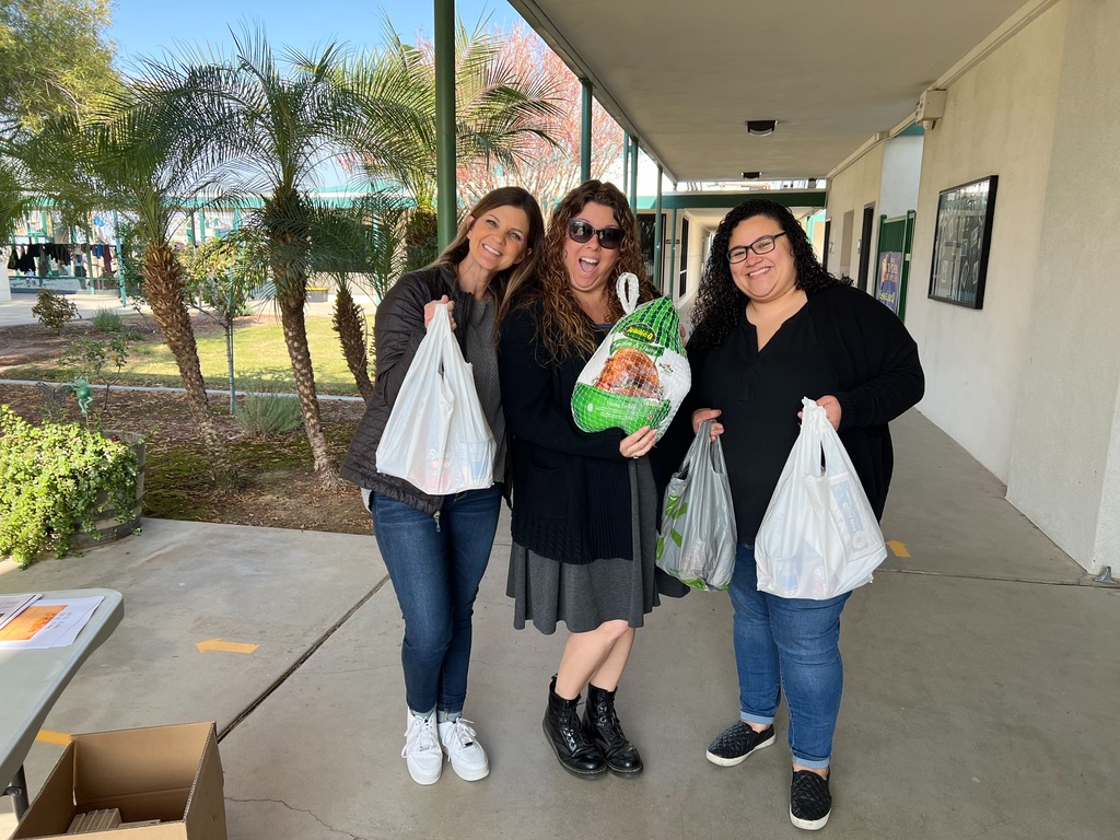 staff with groceries bags full of items to give away at the meal drive