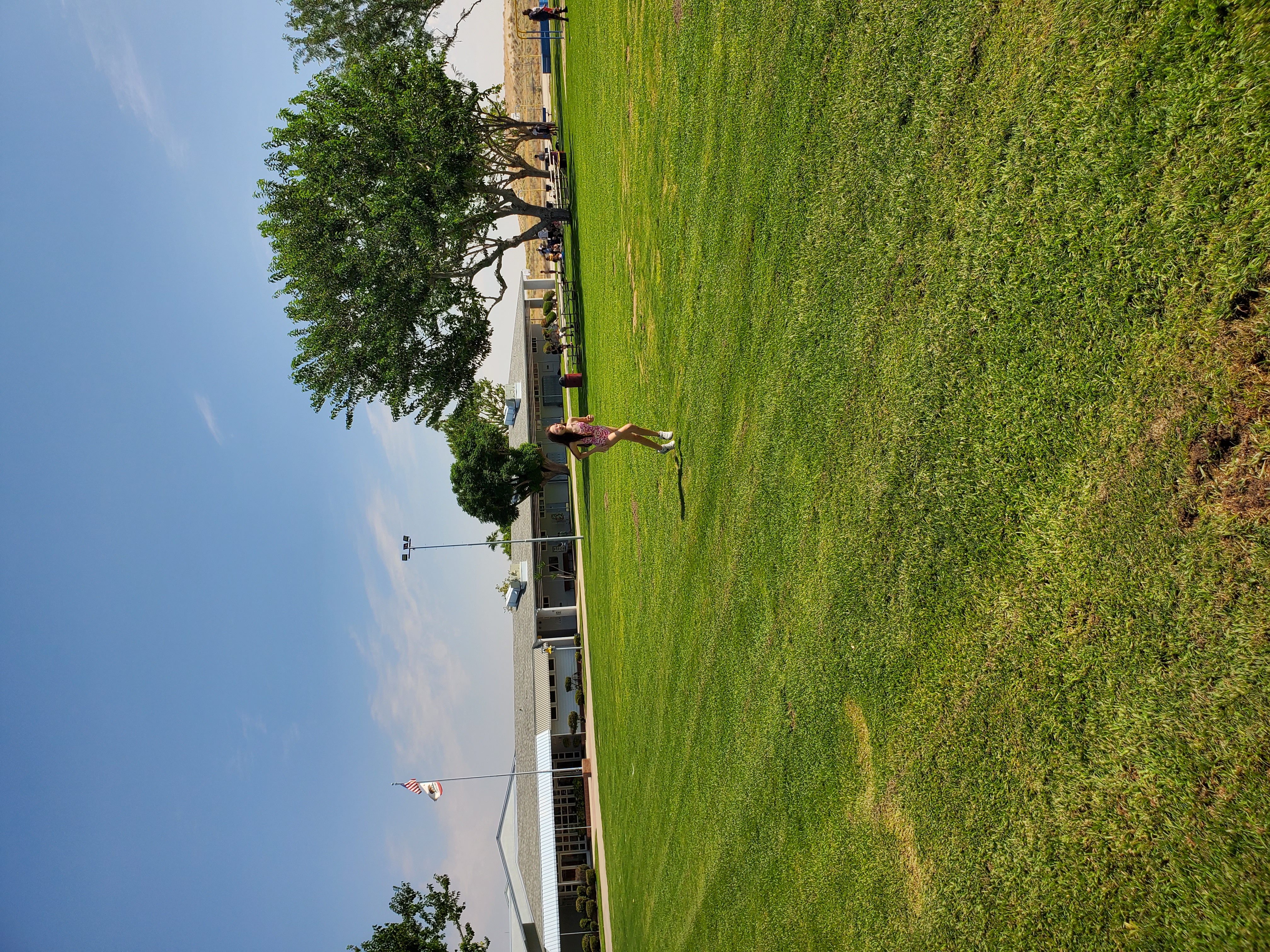 Student running on grass field