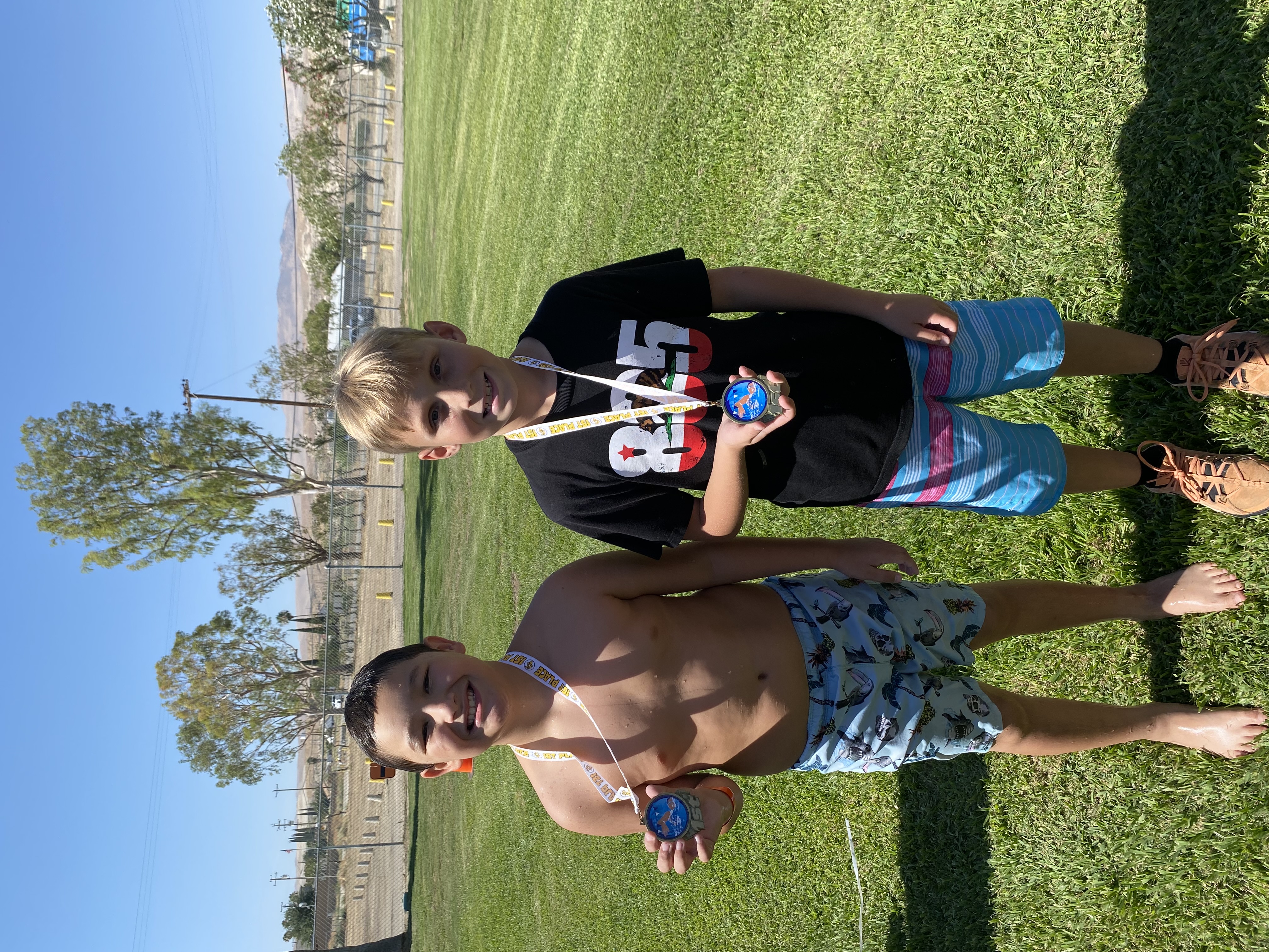 Two male students holding medals