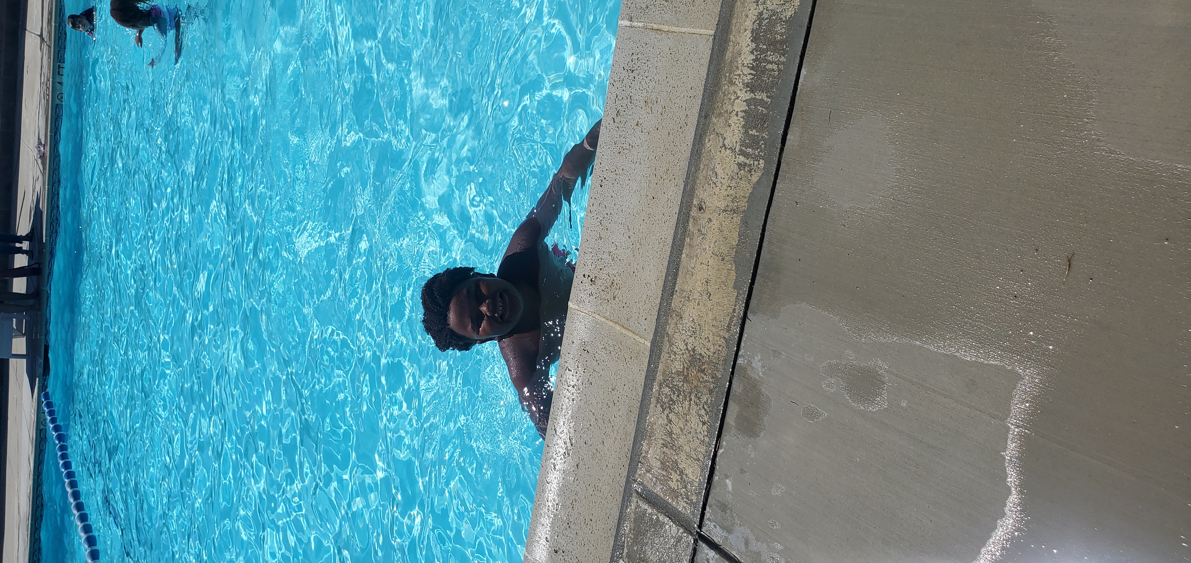 Student smiling in pool