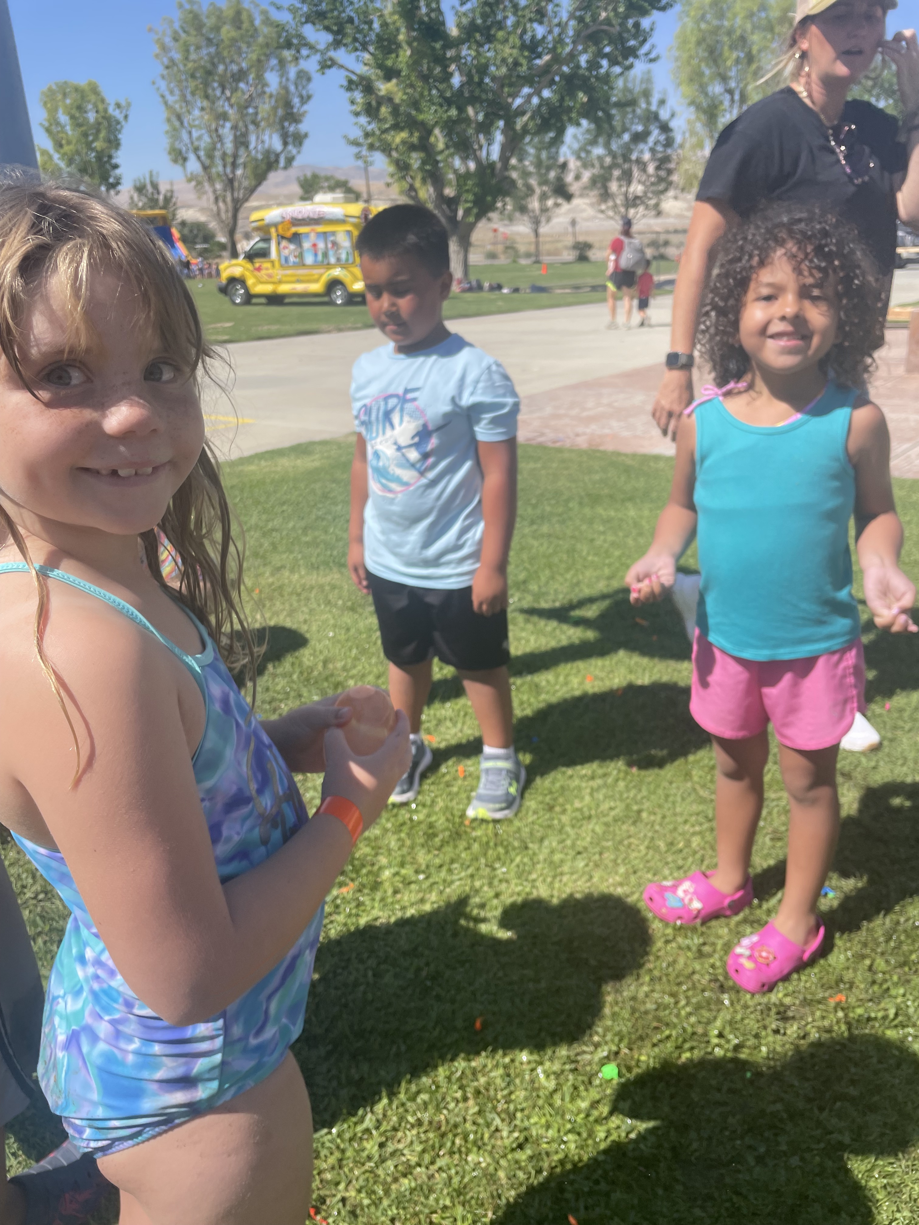 Students standing on grass smiling