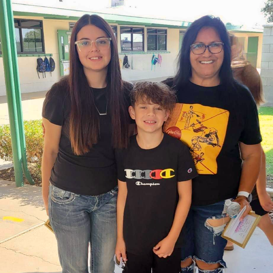 Two student with grandma during Grandparents' Day celebration