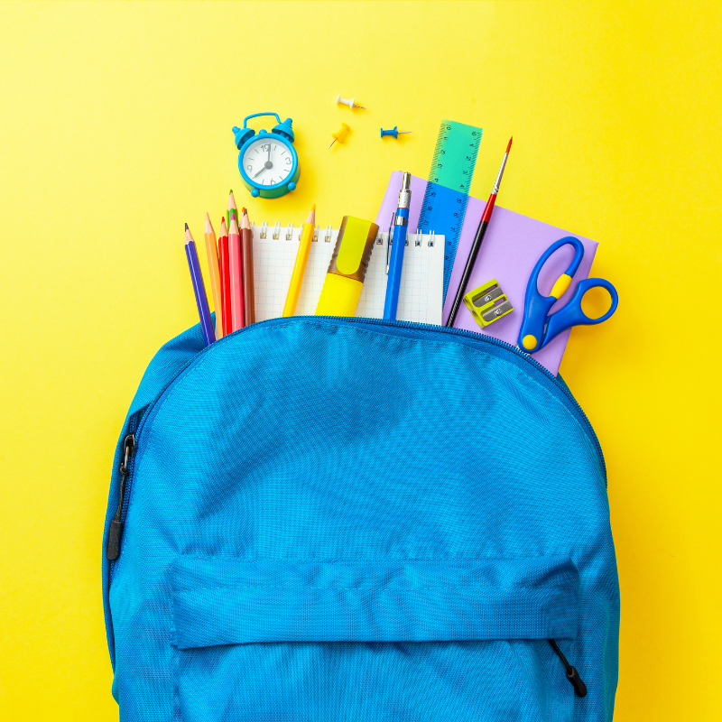photo of backpack holding assorted school supplies